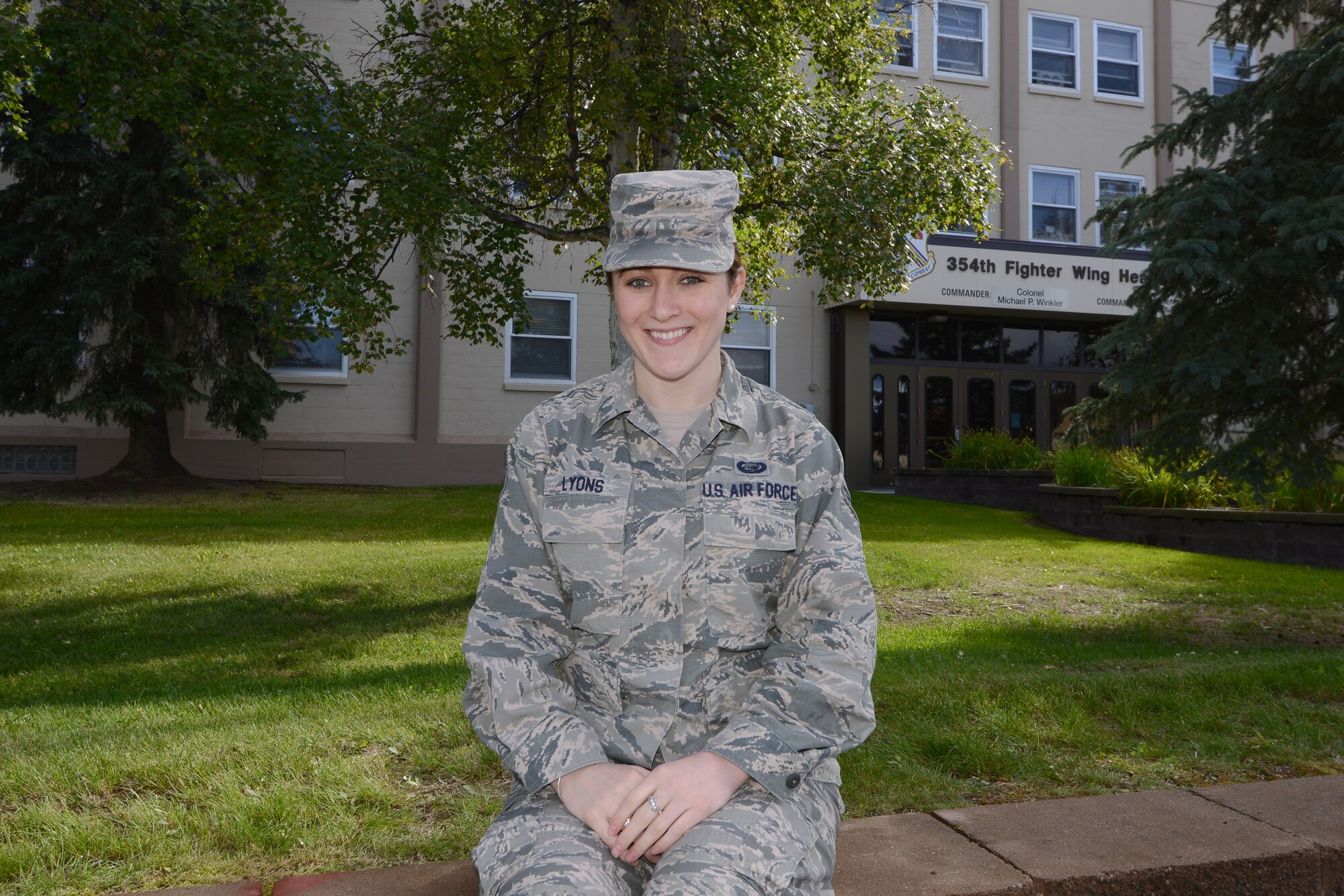 U.S. Air Force Senior Airman Alicia Lyons, a 354th Force Support Squadron career development journeyman, stops work for a brief photo in front of Amber Hall, Aug. 11, 2015, at Eielson Air Force Base, Alaska. Lyons said her favorite part of the job is when she can assist Airmen to reach their long-term career goals. (U.S. Air Force photo by Senior Airman Ashley Nicole Taylor/Released)