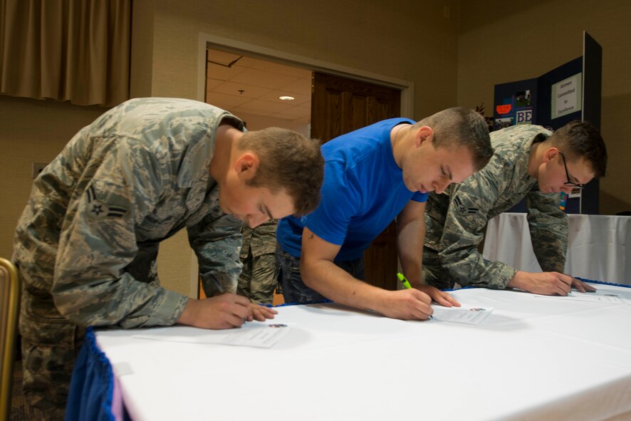 Airmen Committed to Excellence members fill out membership and volunteer forms during a general membership meeting Aug. 13, 2015, at Moody Air Force Base, Ga. The meeting focused on organizing future volunteer projects, organization recruitment and peer networking. Moody’s first ACE organization was founded in 2003. (U.S. Air Force photo by Airman 1st Class Dillian Bamman/Released)