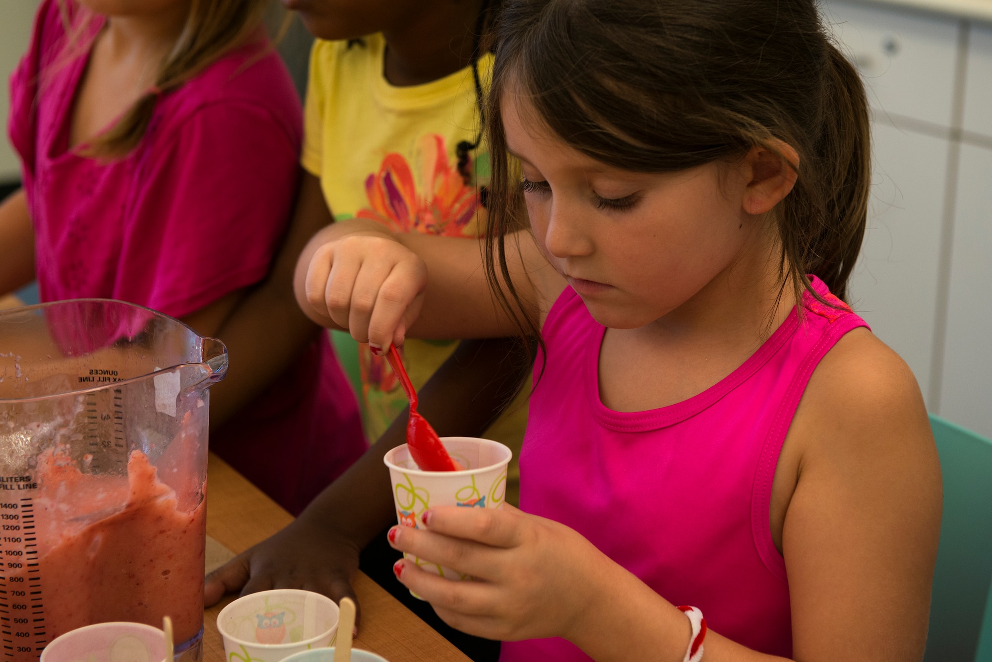 Zooey Stone, daughter of U.S. Air Force Tech. Sgt. Katie Hester, 23d Civil Engineer Squadron, prepares popsicles for a family meal during Kids Eat Right Month, Aug. 12, 2015, at Moody Air Force Base, Ga. Erin Locke, 23d Medical Group health promotion dietitian, taught a nutrition class to the children prior to the event to help families shop smart, cook healthy and eat right. (U.S. Air Force photo by Airman 1st Class Kathleen D. Bryant/Released)