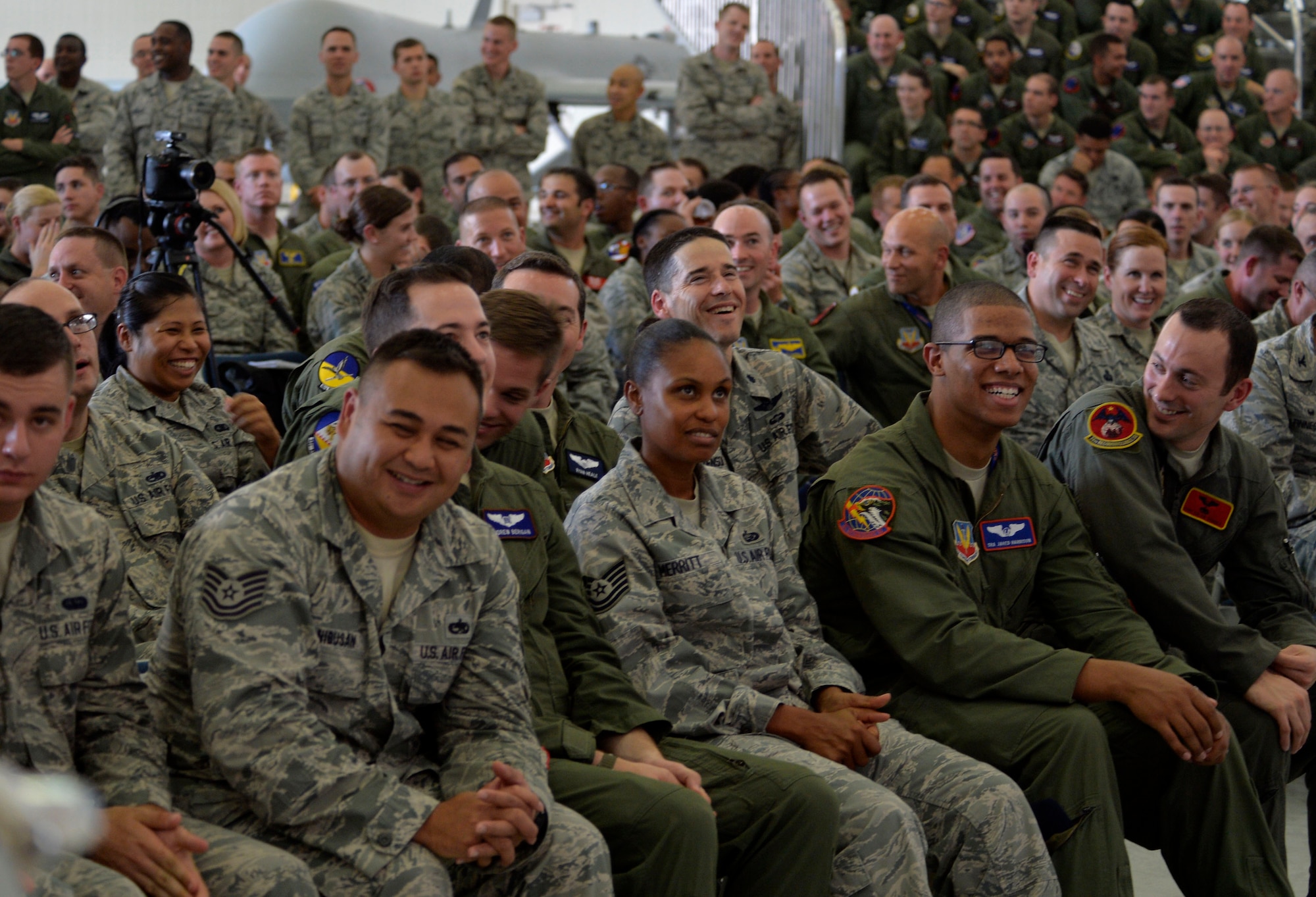 Members of Creech Air Force Base laugh during an all-call by Army Gen. Martin E. Dempsey, Chairman of the Joint Chiefs of Staff, Aug. 12, 2015, at Creech Air Force Base, Nevada. During his visit to Creech AFB, Dempsey and his wife Deanie toured the base to ask the Creech Airmen questions. (U.S. Air Force photo by Airman 1st Class Christian Clausen/Released) 