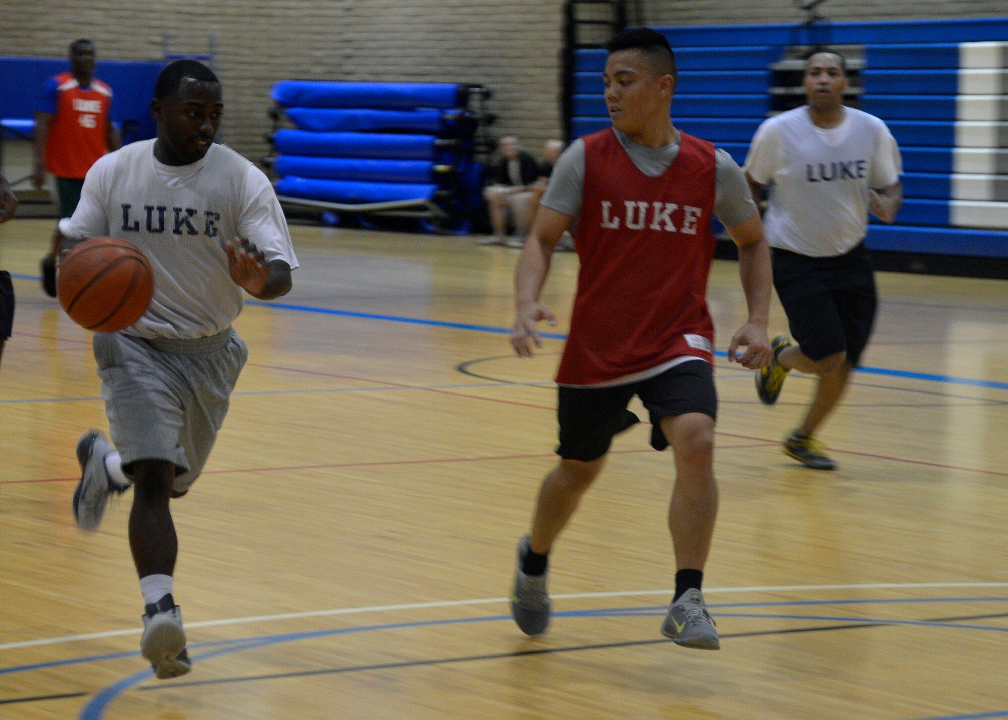 Koraye Williams, 56th Comptroller Squadron, drives to the basket during an intramural basketball playoff game against the 607th Air Control Squadron at Luke Air Force Base, Ariz., August 10, 2015. AAFES defeated 607 ACS 69-41. (U.S. Air Force photo by Senior Airman Devante Williams)