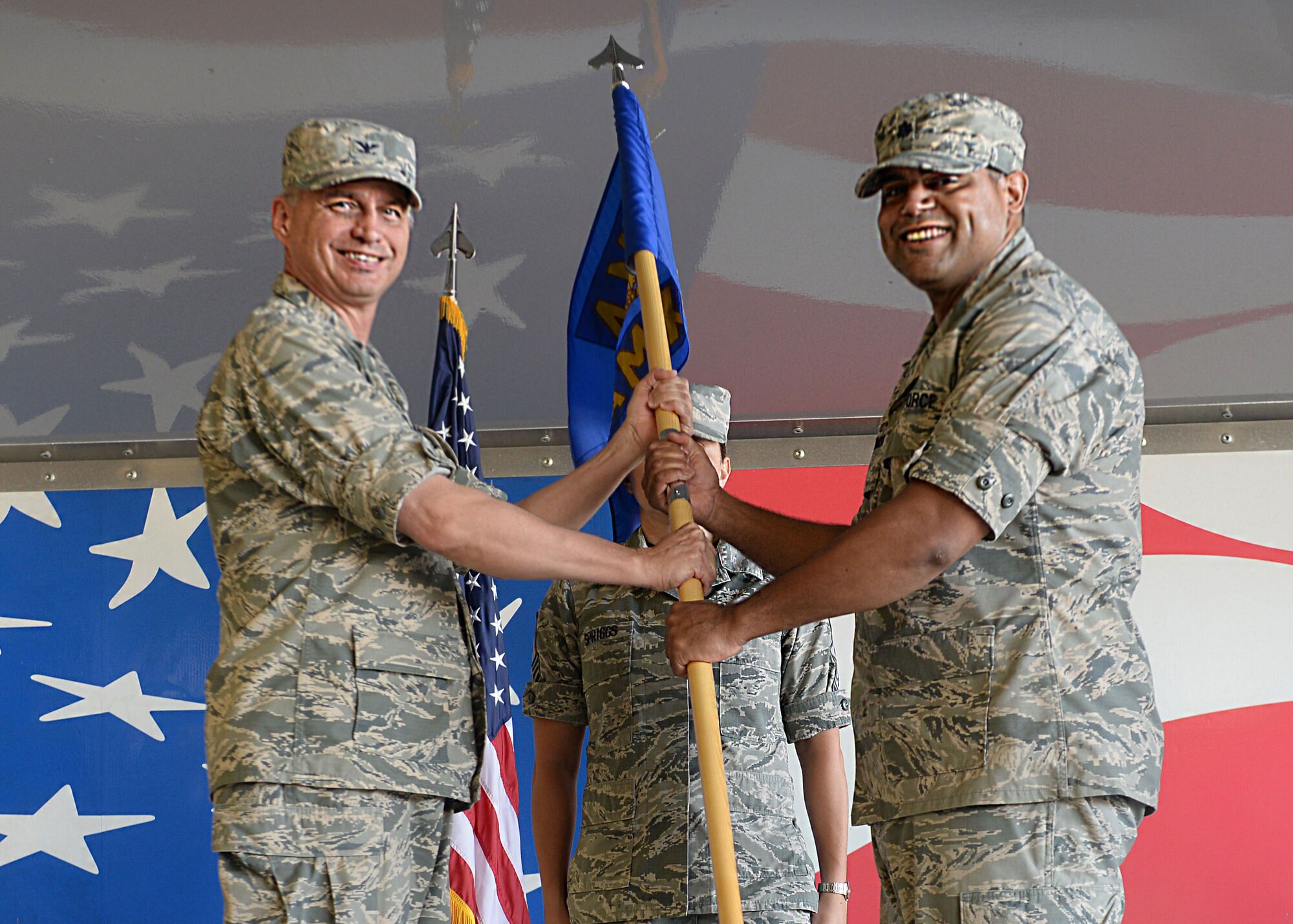 (Left) Lt. Col. Edwin Germosen, incoming 4th Aircraft Maintenance Squadron commander, accepts the guidon from Col. Shannon Cooper, 4th Maintenance Group commander, during a change of command ceremony Aug. 14, 2015, at Seymour Johnson Air Force Base, North Carolina. Most recently, Germosen was the commander of the 509th Maintenance Squadron, at Whiteman Air Force Base, Missouri. (U.S. Air Force photo/Airman 1st Class Ashley Williamson)
