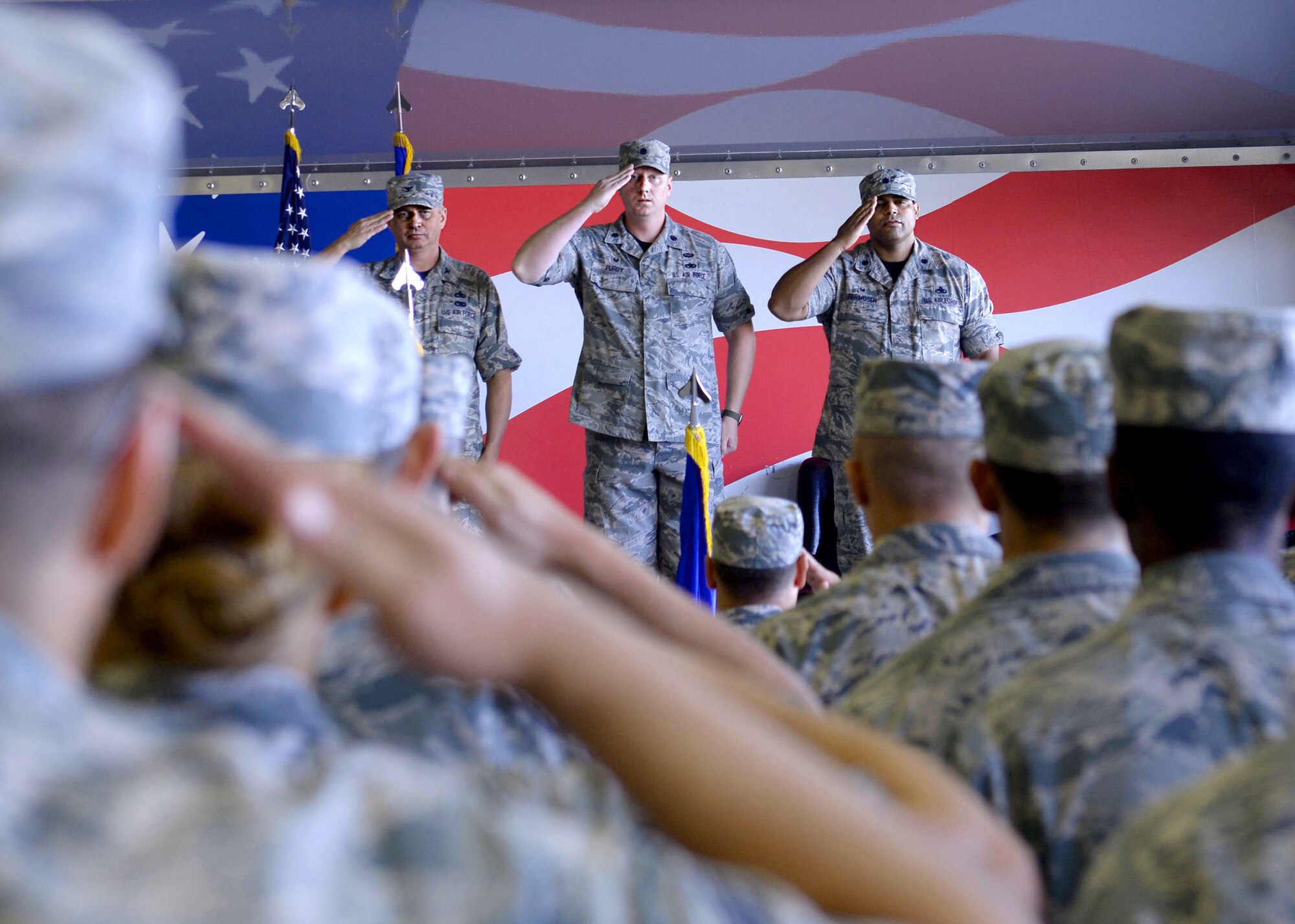 (From left) Col. Shannon Cooper, 4th Maintenance Group commander, Lt. Col. Jason Purdy, outgoing 4th Aircraft Maintenance Squadron commander, and Lt. Col. Edwin Germosen, incoming 4th AMXS commander, salute the flight during the squadron’s change of command Aug. 14, 2015, at Seymour Johnson Air Force Base, North Carolina. The unit supports four F-15E Strike Eagle squadrons and is tasked to deploy worldwide as part of the Air Expeditionary Force. (U.S. Air Force photo/Airman 1st Class Ashley Williamson)