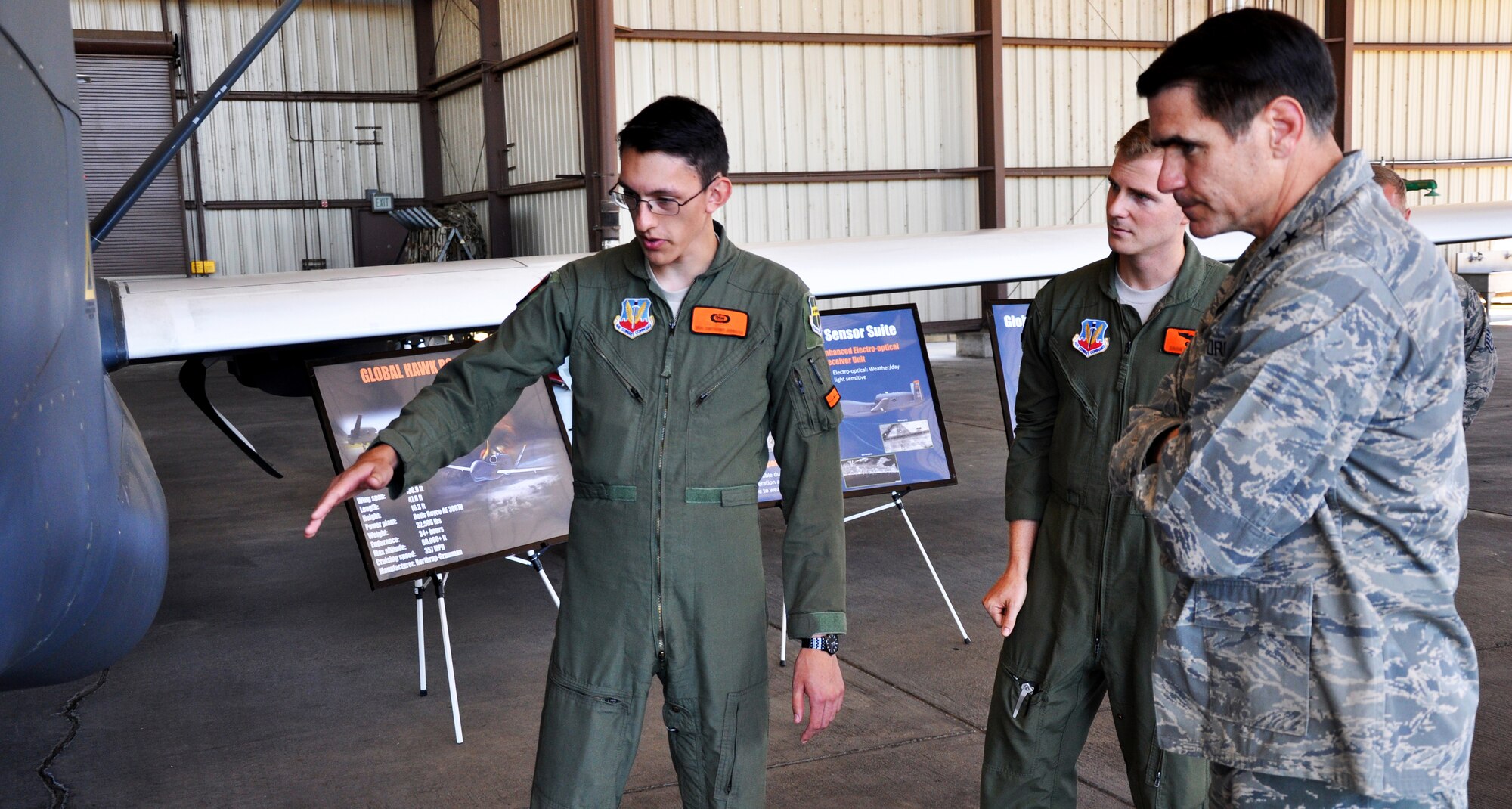Maj. Gen. Bradford "B.J." Shwedo (right), 25th Air Force commander, is briefed by Senior Airman Anthony on the capabilities of the RQ-4 Global Hawk aircraft  Aug. 13, 2015, at Beale Air Force Base, California. The visit to Beale was Shwedo’s first since assuming command of the 25th Air Force. The 25th Air Force includes the 9th Reconnaissance Wing, the 7th, 363rd, and 480th Intelligence, Surveillance and Reconnaissance Wings; the 55th Wing and the Air Force Technical Applications Center. (U.S. Air Force photo by Jeffrey M. Schultze)