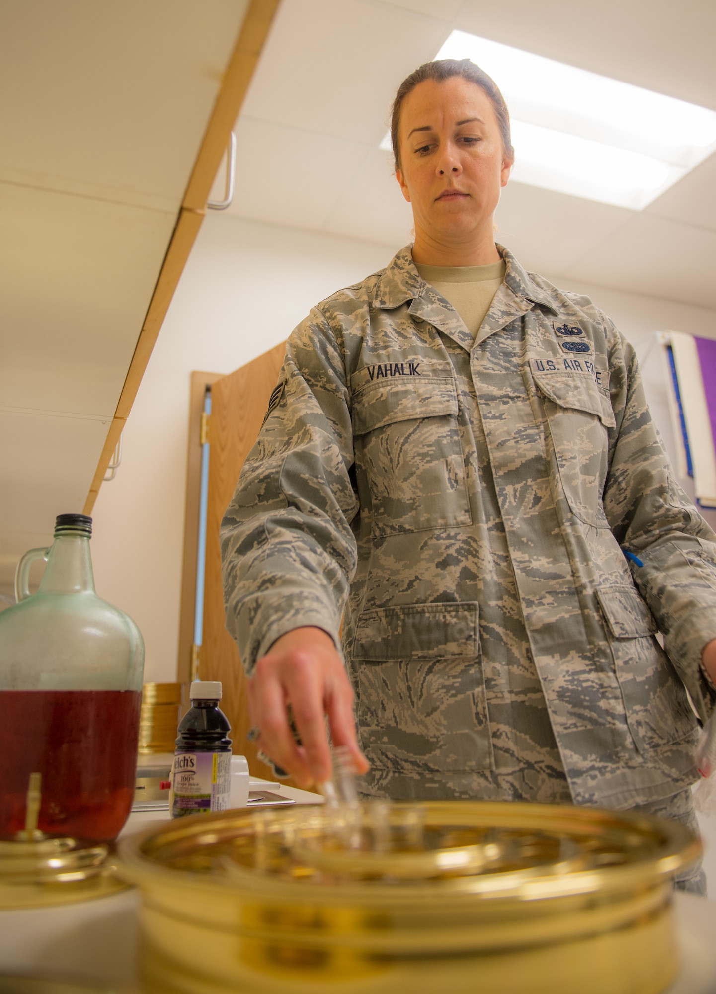 U.S. Air Force Staff Sgt. Jen Vahalik, the 354th Fighter Wing NCO in-charge of chapel plans and programs, prepares communion prior to a service July 29, 2015, in the Base Chapel at Eielson Air Force Base, Alaska. Vahalik assists chaplains, who help provide moral and spiritual growth opportunities for the military community and their dependents.  (U.S. Air Force photo by Staff Sgt. Shawn Nickel/Released)