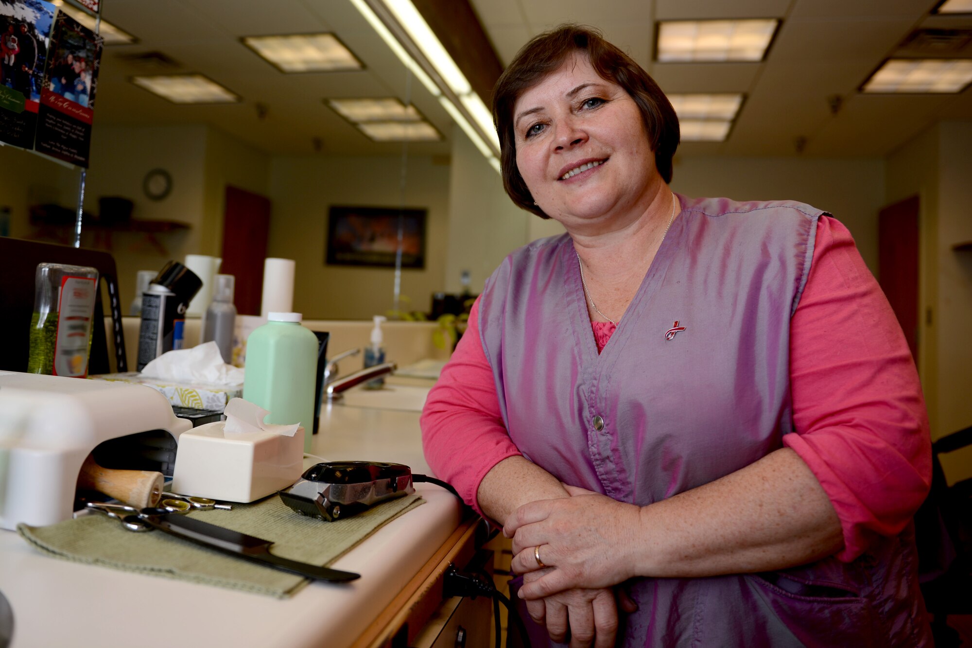 Lyubov Smirnova, McChord Club barber, poses for a photo Aug. 11, 2015, at Joint Base Lewis-McChord, Wash. Smirnova moved to the U.S. in 1999 from Donetsk, Ukraine to avoid religious prosecution and has worked on McChord Field for more than 13 years. (U.S. Air Force photo/Airman 1st Class Keoni Chavarria)