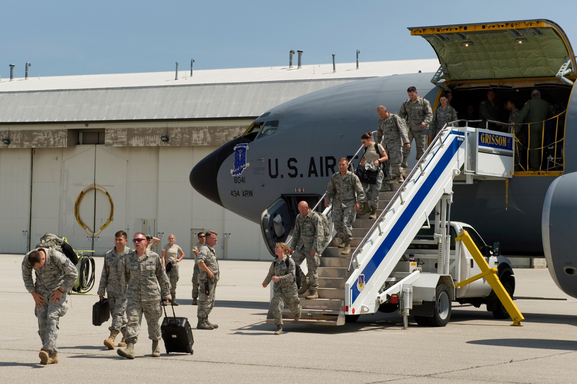 Members of the 434th Security Forces Squadron exit a KC-135R Stratotanker, after returning to Grissom Air Reserve Base, Ind., August 8, 2015. The defenders were the last group from their unit to return from Southwest Asia following a deployment of approximately 60 434th SFS Airmen supporting Operation Inherent Resolve. (U.S. Air Force photo/Tech. Sgt. Benjamin Mota)