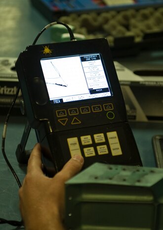 Joey Mabrey, a contractor with the 57th Maintanence Group, finds a crack inside an
aircraft part using an eddy current at the Nondestructive Inspection Laboratory on
Nellis Air Force Base, Nev., Aug. 11. An eddy current is an electric current in a conducting material that can show cracks unseeable to the human eye. (U.S. Air Force photo by Airman 1st Class Rachel Loftis)