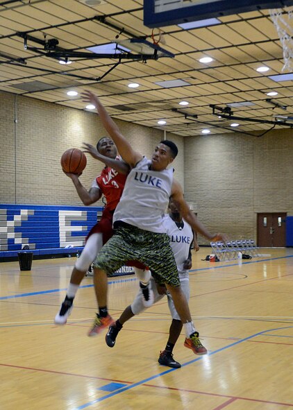 Hanniel Julien, 56th Logistics Readiness Squadron, performs a layup during an intramural basketball game against the 56th Aircraft Maintenance Squadron Aug. 3 at Luke Air Force Base. AMXS defeated LRS 48-42.