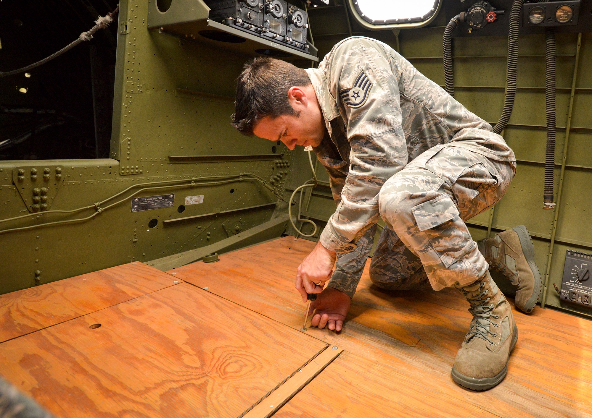 Tech Sgt. Garrett Hulett, Barksdale Global Power Musuem Non-Commissioned Officer in Charge, works on flooring in the interior of the museum’s B-17 Flying Fortress. Hulett maintains the air park’s 20 static displays, including 17 aircraft that span from a World War II B-24 Liberator to an SR-71 Blackbird. (U.S. Air Force photo/Airman 1st Class Mozer O. Da Cunha)