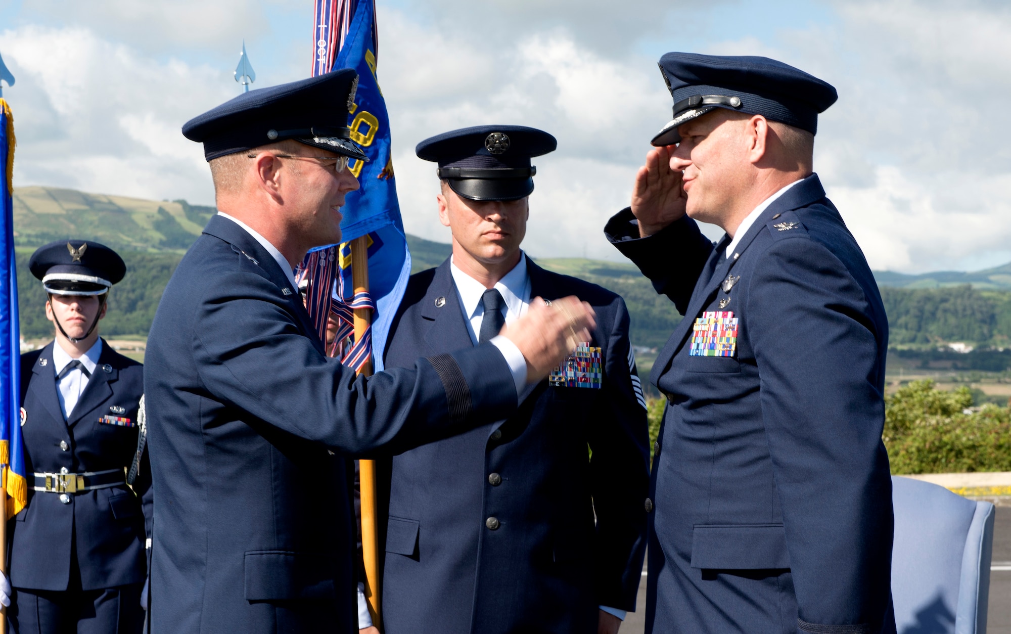 Col. Richard Sheffe, commander of the 65th Air Base Group, salutes Brig. Gen. Jon Thomas, commander of the 86th Airlift Wing, Ramstein Air Base, Germany, while assuming command of the 65th Air Base Group during a Redesignation Ceremony on Lajes Field, Azores, Portugal, August 14, 2015. With this Redesignation Ceremony, the 65th Air Base Group is now aligned under the 86th Airlift Wing and remains positioned to provide agile combat support and services to aircraft and aircrews. (U.S. Air Force photo by Master Sgt. Bradley C. Church)