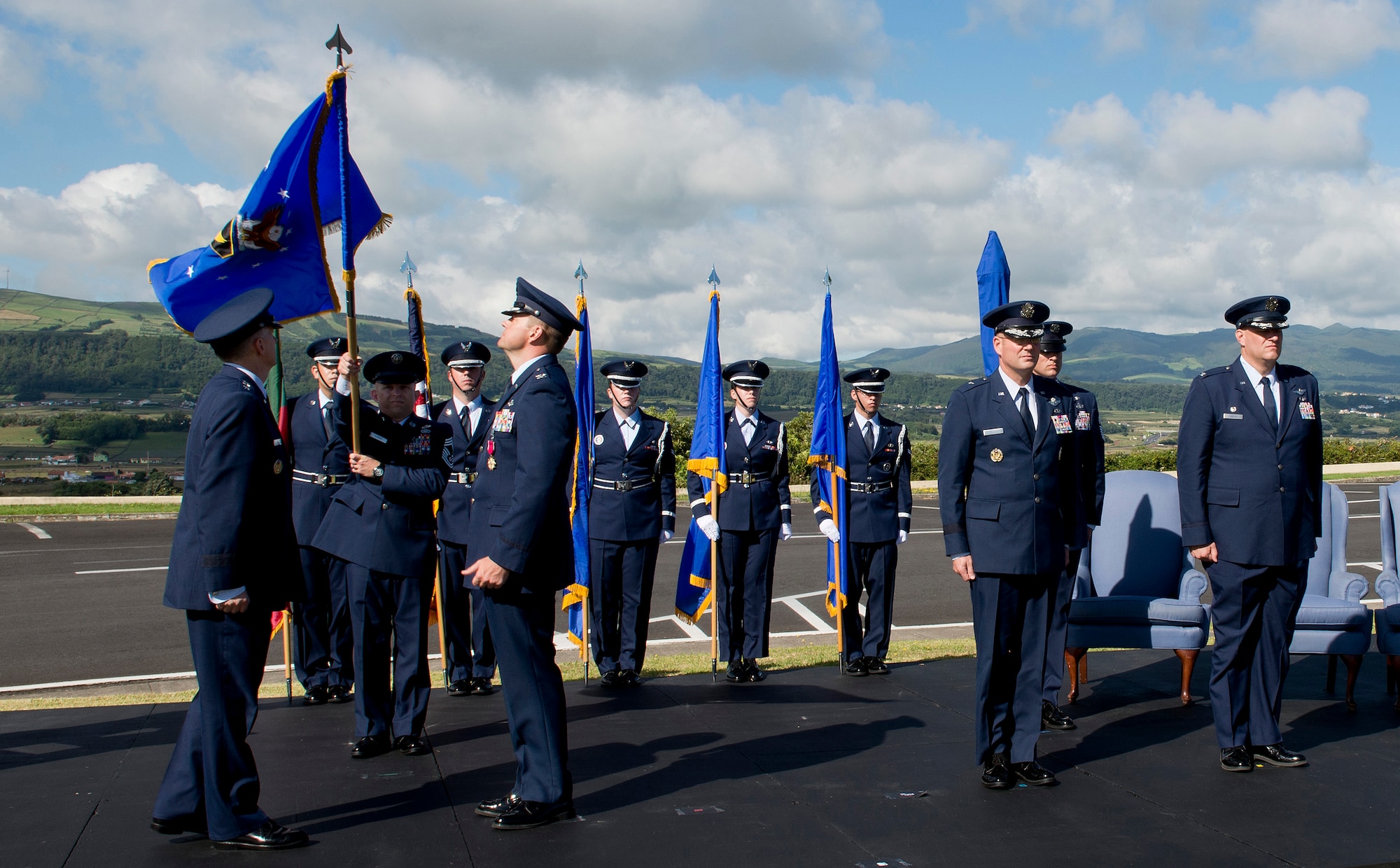 Chief Master Sgt. John Storms, superintendent of the 65th Mission Support Group, lowers the 65th Air Base Wing flag to be furled during a Redesignation Ceremony on Lajes Field, Azores, Portugal, August 14, 2015. With this Redesignation Ceremony the 65th Air Base Group is now aligned under the 86th Airlift Wing and remains positioned to provide agile combat support and services to aircraft and aircrews.  (U.S. Air Force photo by Master Sgt. Bradley C. Church)