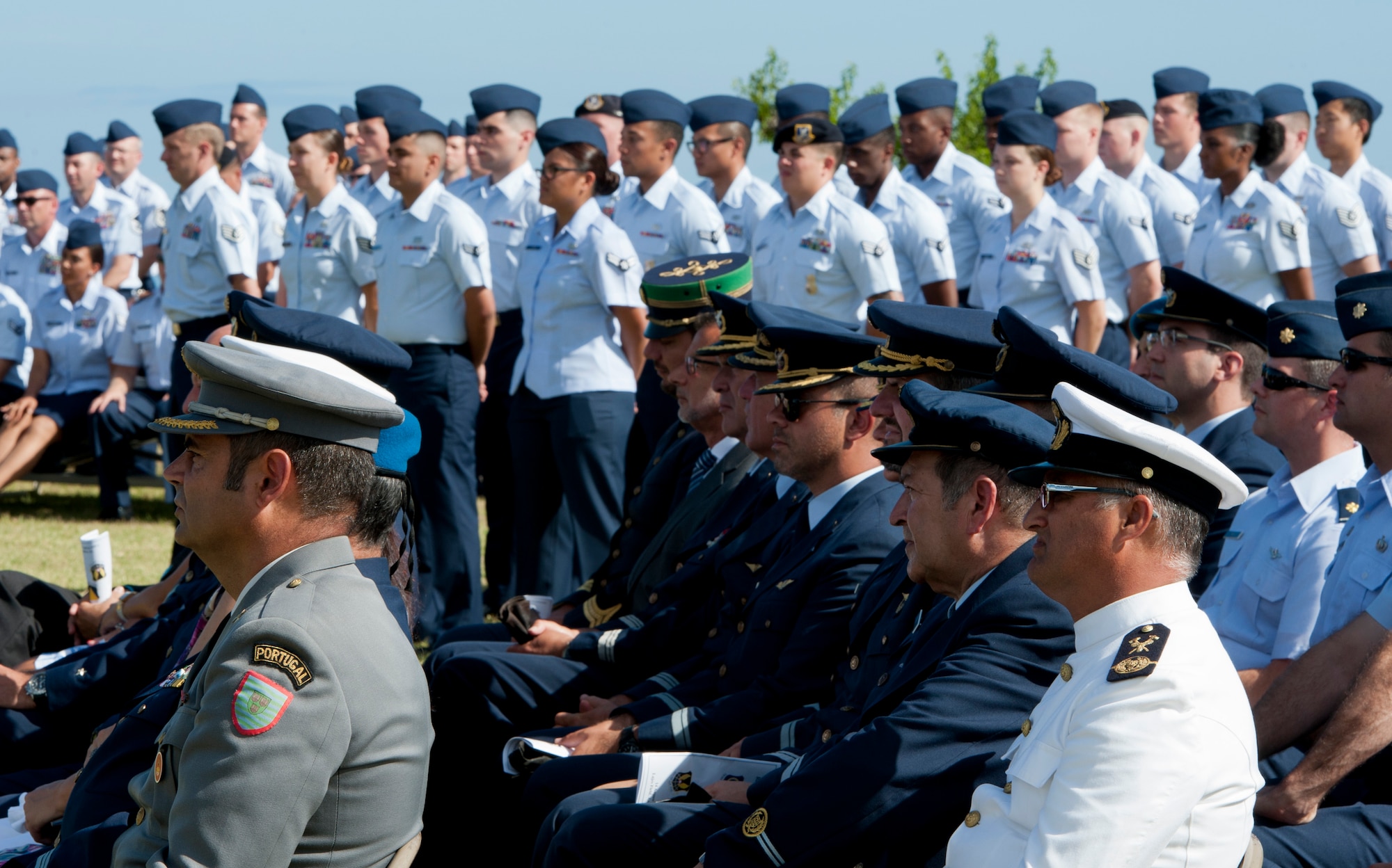 Members of the Portuguese military and U.S. Air Force watch the 65th Air Base Wing’s Redesignation Ceremony on Lajes Field, Azores, Portugal, August 14, 2015. The ceremony redesignated the 65th Air Base Wing into the 65th Air Base Group aligned under the 86th Airlift Wing, Ramstein Air Base, Germany. (U.S. Air Force photo by Master Sgt. Bradley C. Church)
