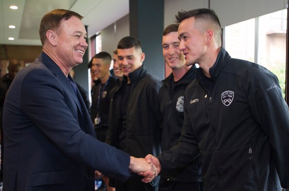 Maj. Gen. Darryl Burke, Air Force District of Washington commander, presents Airman 1st Class Kosie Carty, United States Air Force Honor Guard Drill Team member with his coin in Edinburgh, Scotland, Aug. 14, 2015. Members of the honor guard were recognized by Burke for their participation in the Royal Edinburgh Military Tattoo. (U.S. Air Force photo/Staff Sgt. Nichelle Anderson/released)