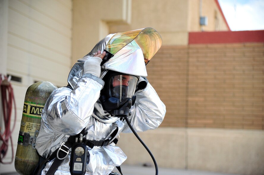 Renso completes the bunker drill by putting on the crash gear helmet. The helmet has a face shield, which protects the face by blocking excess heat.