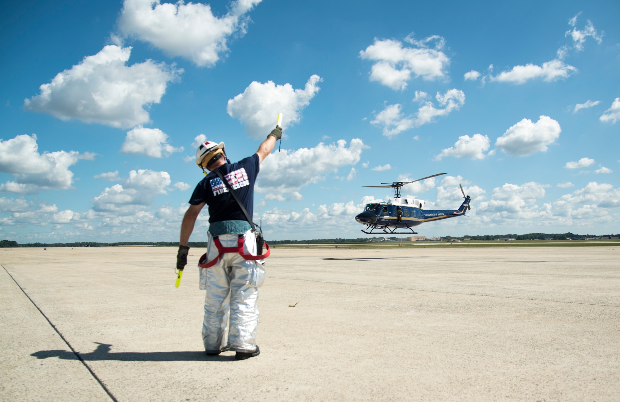 Adam Burak, 11th Wing fire department crew chief, gives the signal to take off during an emergency-readiness exercise after loading the simulated patient onto a UH-1N Huey on the flight line of Joint Base Andrews, Md., Aug. 15, 2015. The 11th Civil Engineer Squadron fire department worked alongside the 11th Security Forces Squadron, 79th Medical Wing and the 1st Helicopter Squadron during the exercise. (U.S. Air Force photo/Airman 1st Class Philip Bryant)