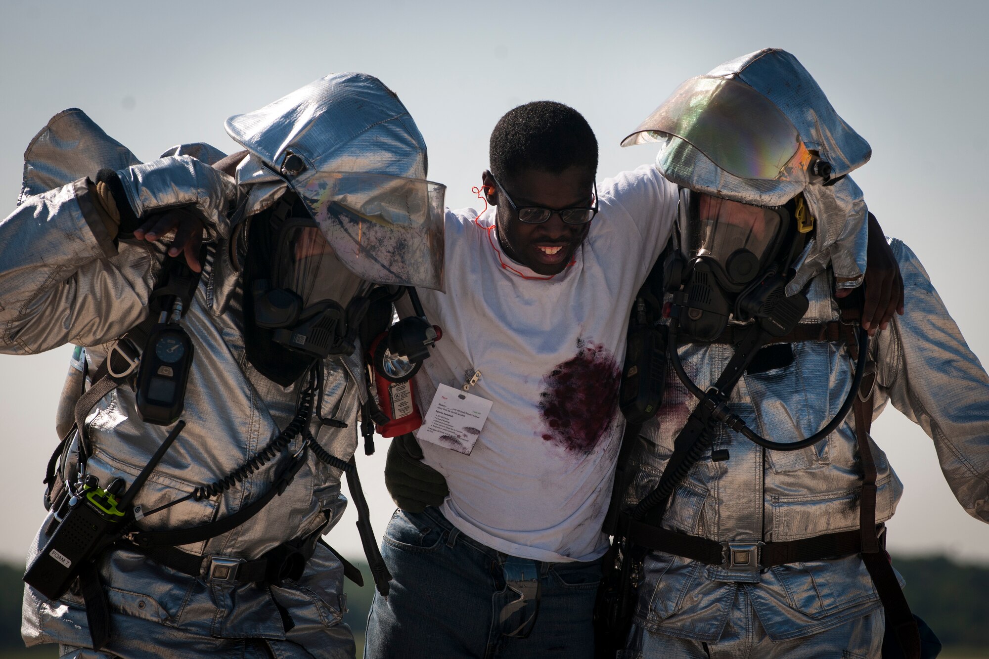 Senior Airman Christopher Springs, exercise volunteer, gets carried off the flight line on Joint Base Andrews, Md., during an emergency-readiness exercise Aug. 13, 2015. Exercise volunteers with mock injuries role-played during the exercise to create a realistic training environment. (U.S. Air Force photo/Airman 1st Class Philip Bryant)