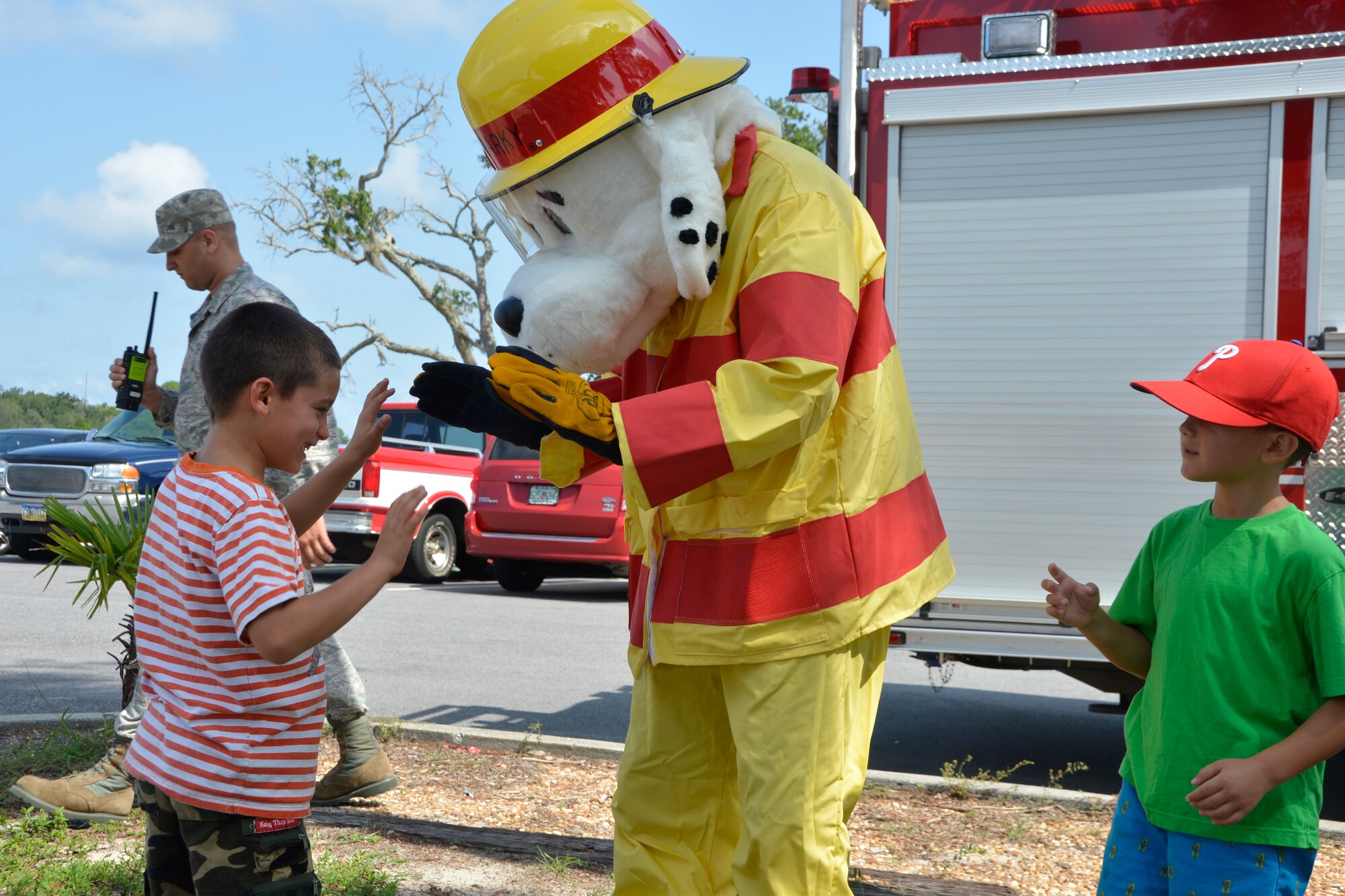 A young visitor greets Sparky the Fire Dog during the 1st Air Force (Air Forces Northern) “Family Day 2015” Aug. 7 at Bonita Bay. The day focused on taking care of the organization’s families and featured a variety of activities that included food and sport competitions, a waterslide and plenty to eat and drink. (Air Force Photo Released/Mary McHale)