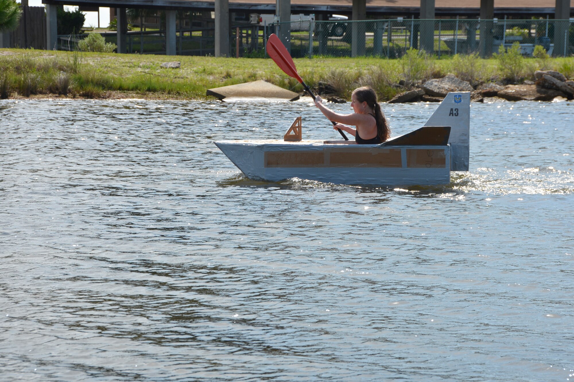 Tech. Sgt. Bridget Behrens, Air, Space & Information Operations Directorate, holds the leader position all alone in the cardboard boat race during the 1st AF (AFNORTH) “Family Day 2015” at Bonita Bay Aug. 7. The race, which she won, kicked off the day which focused on taking care of the organization’s families and featured a variety of activities that included food and sport competitions, a waterslide and plenty to eat and drink. (Air Force Photo Released/Mary McHale)