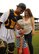 Tech. Sgt. Gabriel Phillips, Air Force Officer Training School, 22nd Training Squadron physical conditioning instructor, embraces his son, Kamryn, for the first time since returning from his six-month deployment July 30, 2015, in Montgomery, Alabama. Kamryn threw the first pitch to kick start the game at Montgomery Riverwalk Stadium and was surprised to find that the catcher was his dad. (U.S. Air Force photo by Airman 1st Class Alexa Culbert)