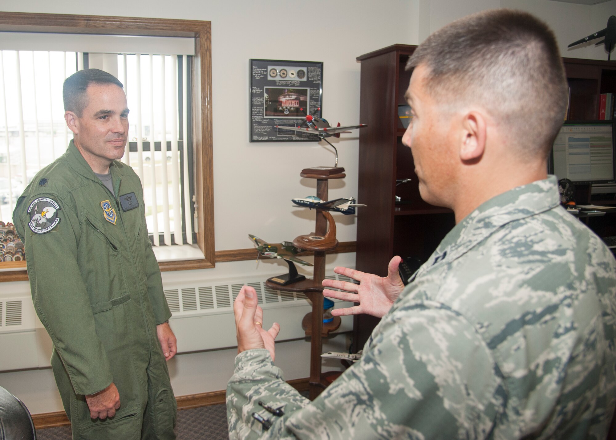 Lt. Col. Charles Throckmorton, 436th Operations Support Squadron director of operations, talks with Chaplain (Capt.) Quentin Genke, 436th Airlift Wing chaplain, August 7, 2015, on Dover Air Force Base, Del. Chaplains patrol different locations on base to ensure Airmen know that chaplains are always willing to lend an ear. (U.S. Air Force photo/Senior Airman Jared Duhon) 