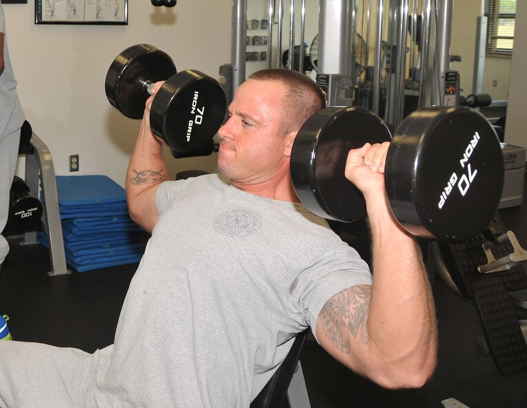 Hamilton uses free weights to work on his upper body strength. (U.S. Air Force photo by Misuzu Allen)