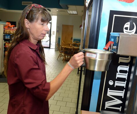 Allison Heard, Bldg. 301 East Wing snack bar cashier, brews a fresh pot of coffee for patrons Aug 12, 2015. (U.S. Air Force photo by Tommie Horton)