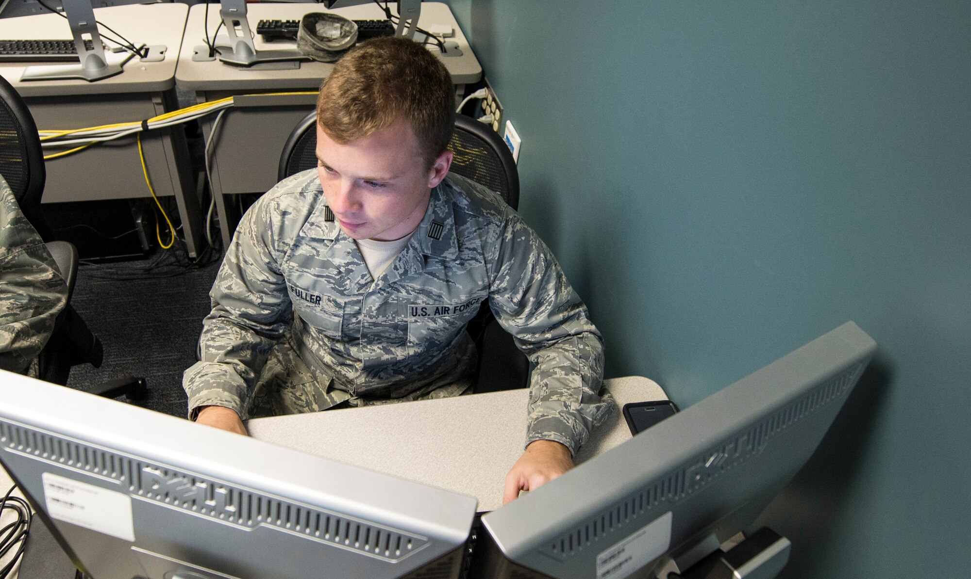 Advanced Cyber Education program cadets at the Air Force Institute of Technology race against two other teams to build a minicomputer network while maintaining their infrastructures, which are purposely vulnerable to attack. The team's progress and new challenges are openly displayed during the two-day competition. (Air Force photo by Wesley Farnsworth)