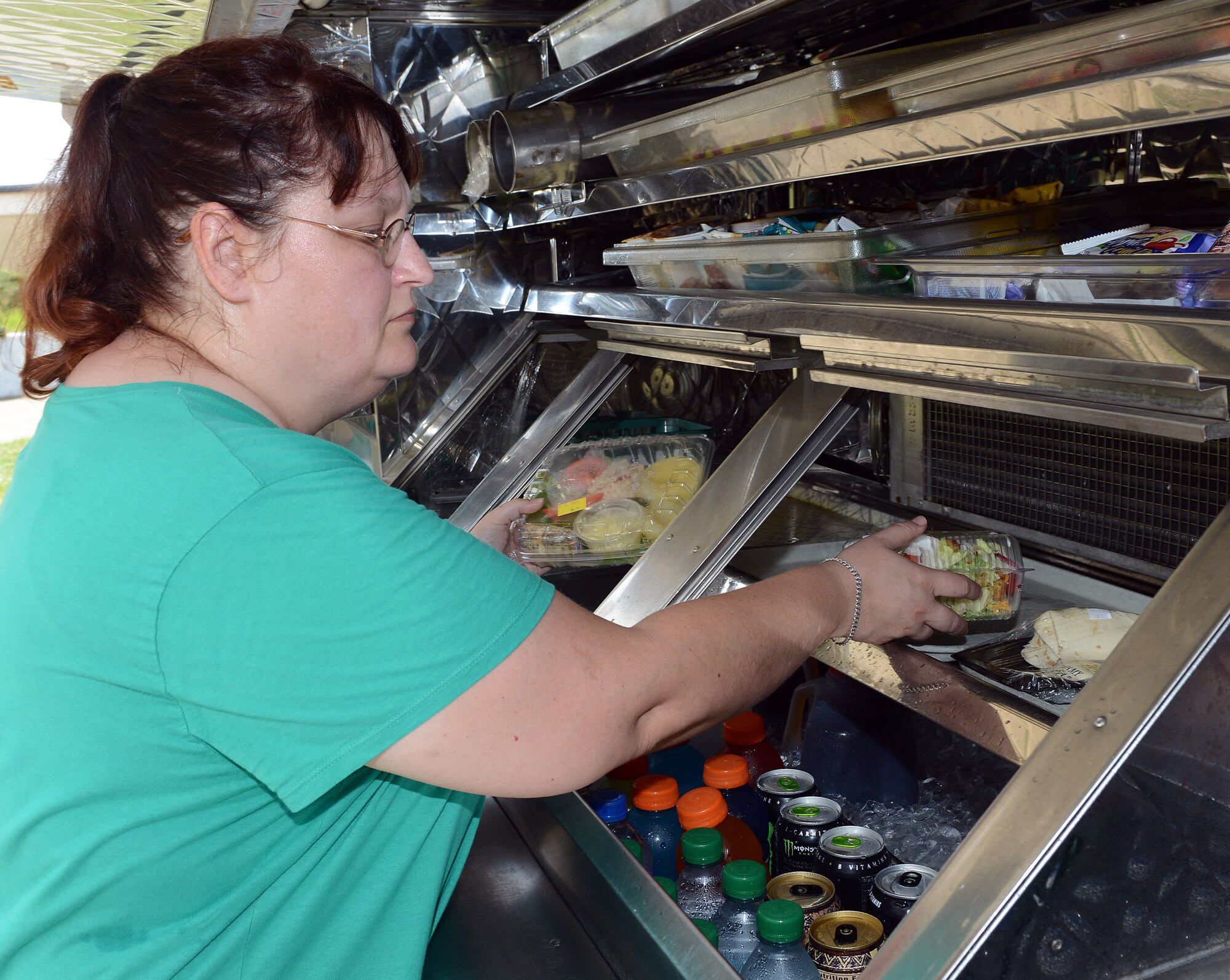 Tonya Kirkpatrick, mobile truck driver, places food items in the truck’s food storage area. 
For a daily menu and snack bar and mobile truck hours visit www.robinsfss.com. (U.S. Air Force photo by Tommie Horton)
