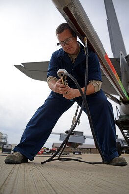 U.S. Air Force Senior Airman Robert Summerville, 100th Maintenance Squadron hydraulics technician from New Castle, Penn., services KC-135 Stratotanker surge boots as part of a required inspection, Aug. 11, 2015, on RAF Mildenhall, England. Surge boots are rubber-like sleeves that run the length of the fuel tube, used as a way to prevent damage during fuel surges when the boom disconnects from the aircraft it is refueling. (U.S. Air Force photo by Senior Airman Christine Halan/Released)