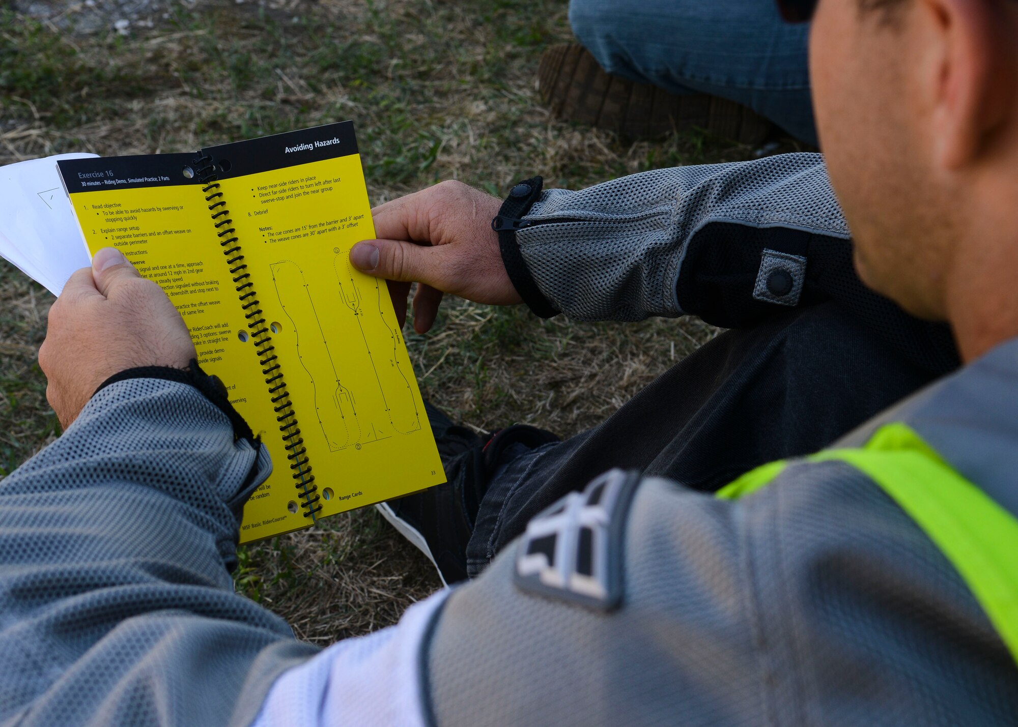 U.S. Army Staff Sgt. Apollo Stoewer, Camp Darby Chapel NCO in-charge, reads over an exercise example during a Riding Coach Preparation Workshop, Aug. 13, 2015, at Aviano Air Base, Italy. Participants were tested on their knowledge of road skills, signs and maneuvers before graduating. (U.S. Air Force photo by Senior Airman Austin Harvill/Released)