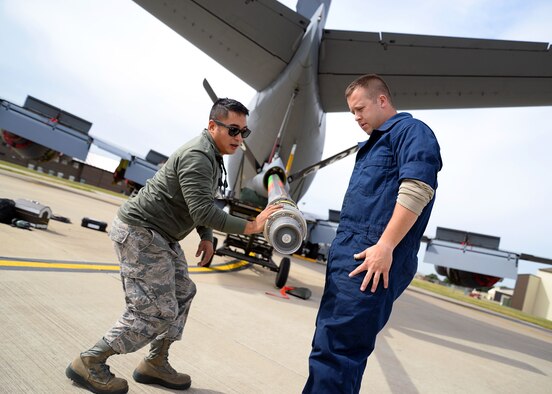 U.S. Air Force Staff Sgt. Albert Salangsang, left, 100th Maintenance Squadron hydraulics technician from Dallas, and U.S. Air Force Senior Airman Robert Summerville, 100th MXS hydraulics technician from Newcastle, Penn., inspect a KC-135 Stratotanker boom nozzle for defects and damage Aug. 11, 2015, on RAF Mildenhall. The Airmen were doing this as part of a required inspection to ensure the aircraft stays mission ready. (U.S. Air Force photo by Senior Airman Christine Halan/Released)