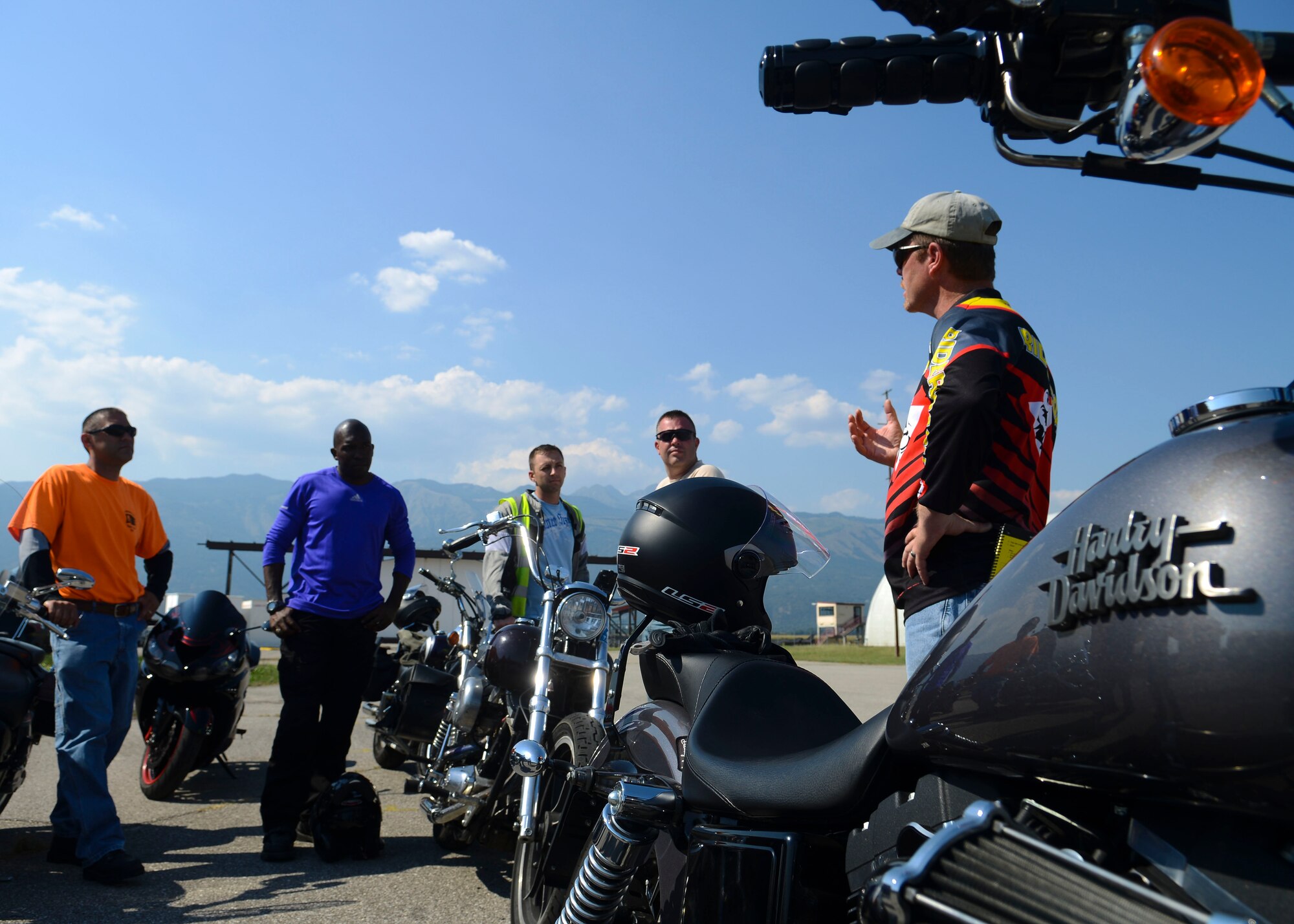 Skip Mace, Motorcycle Safety Foundation riding coach, speaks with students during a Riding Coach Preparation Workshop, Aug. 13, 2015, at Aviano Air Base, Italy. Students demonstrated their riding proficiency as part of the curriculum. (U.S. Air Force photo by Senior Airman Austin Harvill/Released)