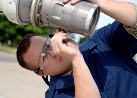 U.S. Air Force Senior Airman Robert Summerville, 100th Maintenance Squardon hydraulics technician from New Castle, Penn., removes corrosion and sealant from a KC-135 Stratotanker boom nozzle Aug. 11, 2015, on RAF Mildenhall, England. Summerville was doing this as part of a required inspection. (U.S. Air Force photo by Senior Airman Christine Halan/Released)