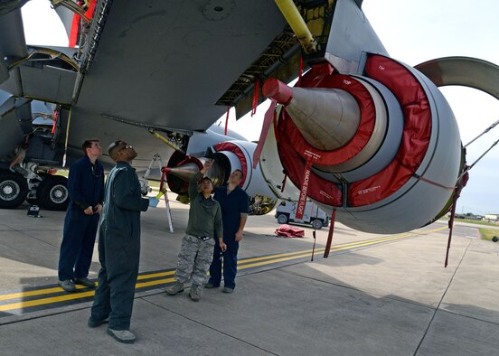 U.S. Air Force Airmen from the 100th Maintenance Squadron survey a potential hydraulic leak on a KC-135 Stratotanker Aug. 11, 2015 on RAF Mildenhall, England. The Airmen were trying to determine the source and severity of the leak. The hydraulics backshop Airmen work closely alongside flight line maintenance Airmen to ensure aircraft are mission ready. (U.S. Air Force photo by Senior Airman Christine Halan/Released)