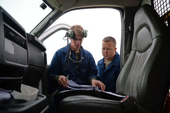 U.S. Air Force Staff Sgt. James Harris, left, 100th Maintenance Squadron hydraulics technician from Abilene, Texas, and U.S. Air Force Senior Airman Robert Summerville, 100th MXS hydraulics technician from New Castle, Penn., review KC-135 Stratotanker aircraft forms Aug. 11, 2015, on RAF Mildenhall, England. Both Airmen were reviewing the forms to ensure the aircraft was safe for maintenance. (U.S. Air Force photo by Senior Airman Christine Halan/Released) 