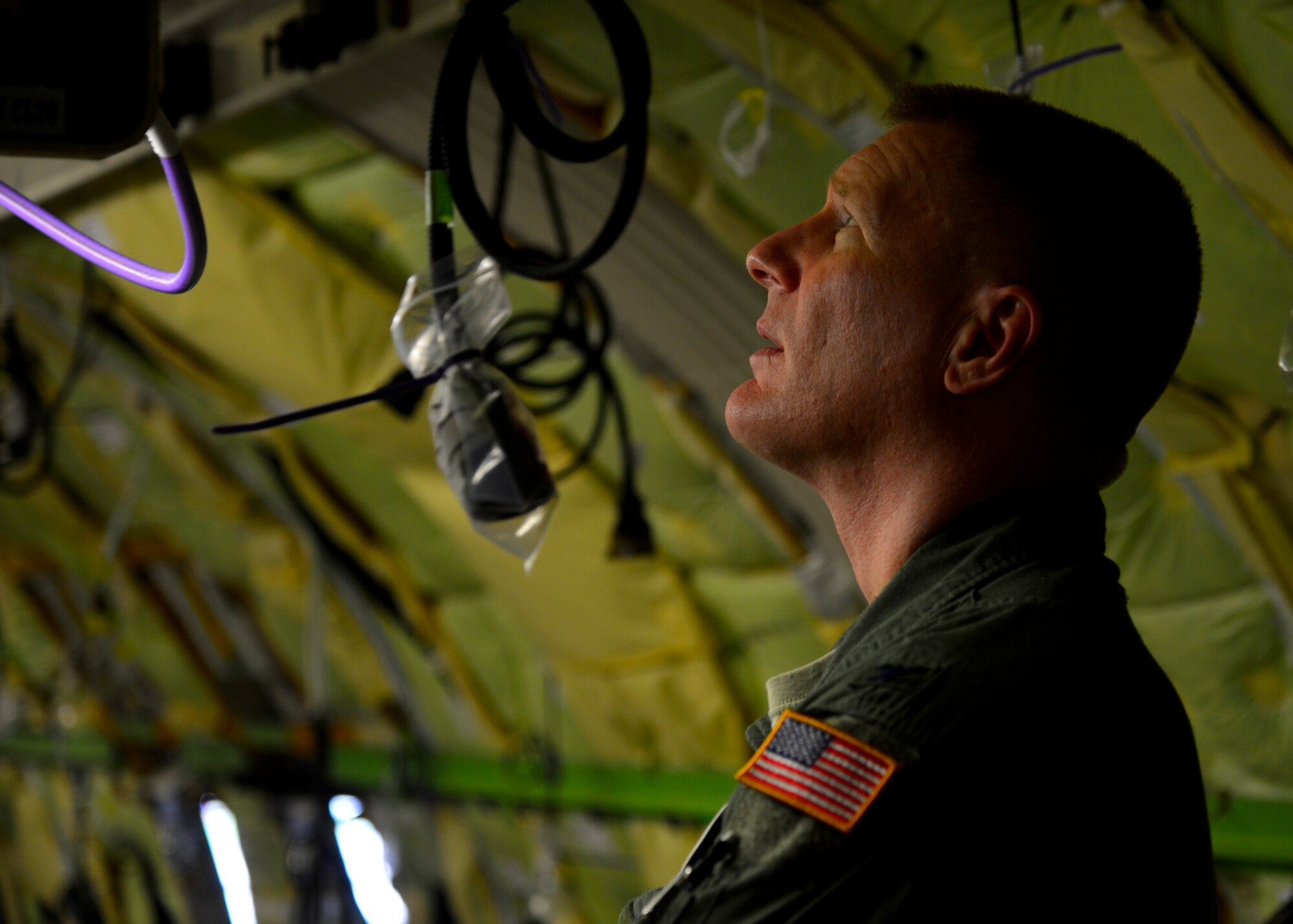 Col. Michael Grismer, 436th Airlift Wing commander, examines the wiring of a Business Boeing jet during a tour of the PATS Aircraft Systems facility Aug. 5, 2015, in Georgetown, Del. Grismer’s honorary commander, Mark Rudo, PATS Aircraft Systems vice president of quality, Organization Designation Authorization  and product support, invited Grismer to see first-hand the various operations conducted by PATS. (U.S. Air Force photo/Airman 1st Class William Johnson)