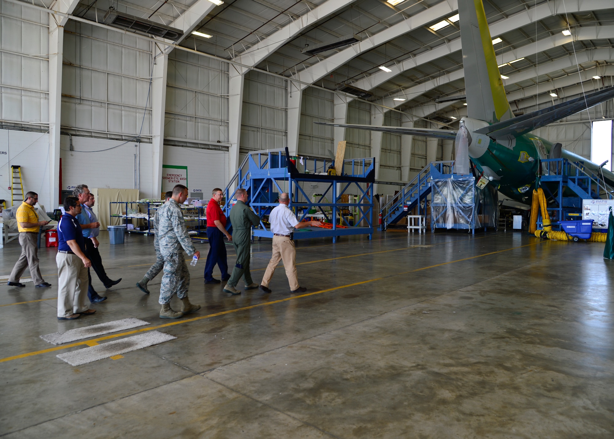 Mark Ryan, PATS Aircraft Systems vice president of Business Boeing Jets and hangar programs, gives a tour of hangar operations to Col. Michael Grismer, 436th Airlift Wing commander, Chief Master Sgt. Keith Davis, 436th AW command chief, and Capt. Derrick Besse, 436th Aircraft Maintenance Squadron operations officer, Aug. 5, 2015, at the PATS Aircraft Systems facility in Georgetown, Del. The tour showcased the mission of PATS and highlighted lean process within their operations. (U.S. Air Force photo/Airman 1st Class William Johnson)