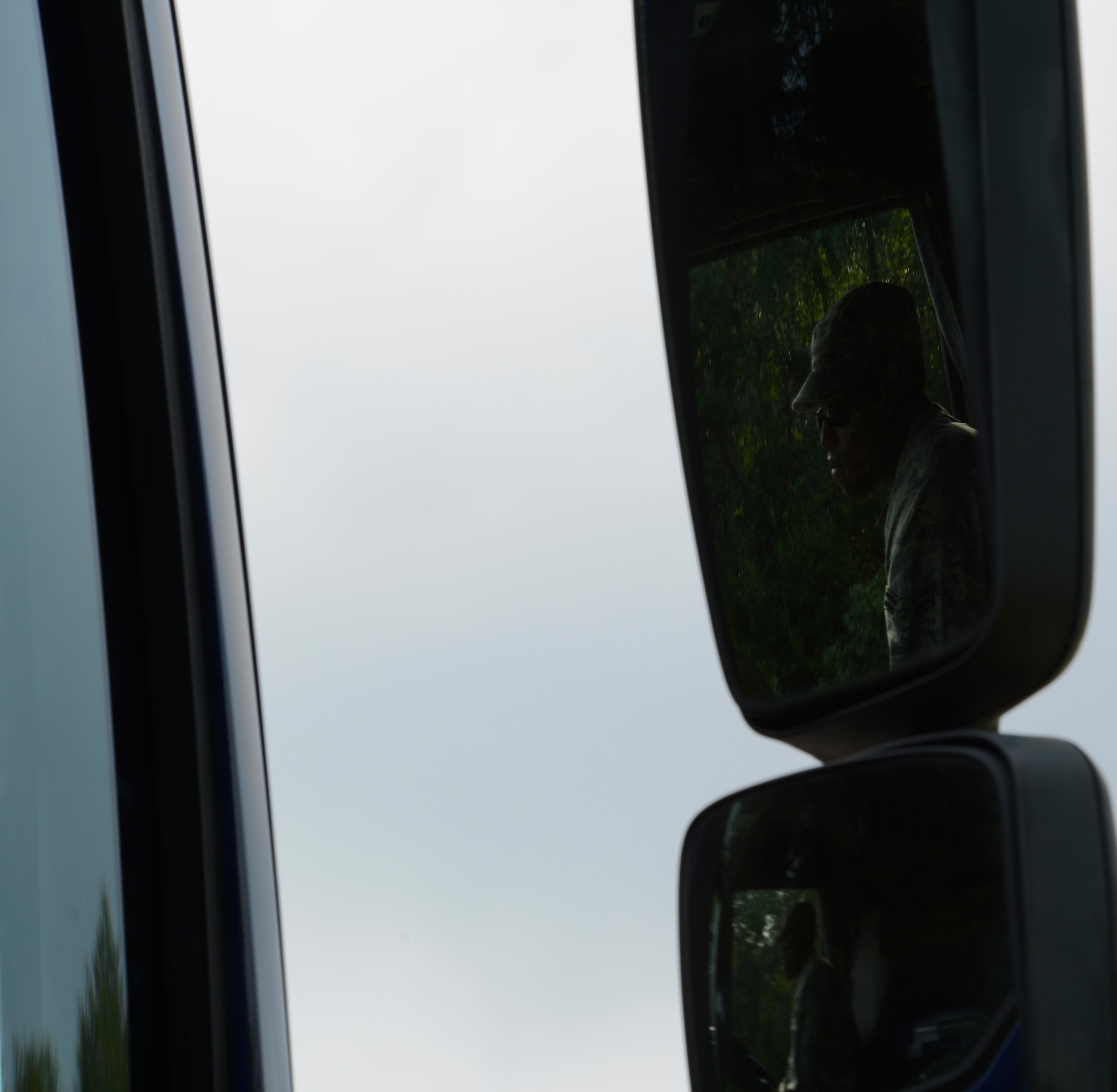 Airman 1st Class Fred Jones, 786th Civil Engineer Squadron heavy equipment operator, waits in the cab of a tractor trailer vehicle for directions from an instructor during the Air Force Civil Engineer Center Tractor Trailer Training program Aug. 10, 2015, at Ramstein Air Base, Germany. This is the first time this program is being taught in U.S. Air Forces in Europe. In it, students learn tractor trailer general knowledge, vehicle inspections, shifting proficiency, advanced backing maneuvers and over-the-road operating skills. (U.S. Air Force photo/Airman 1st Class Tryphena Mayhugh) 