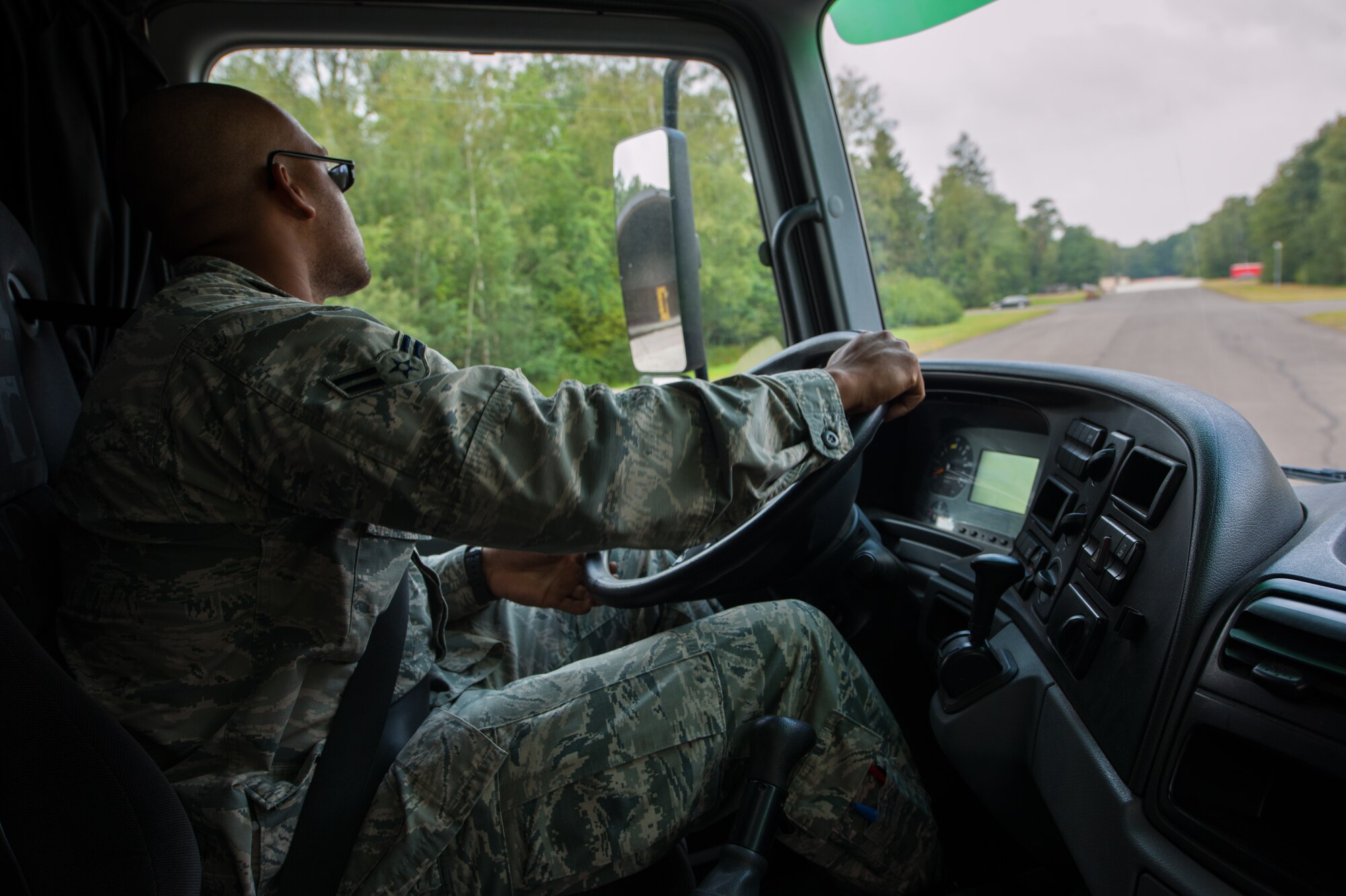 Airman 1st Class Fred Jones, 786th Civil Engineer Squadron heavy equipment operator, drives a tractor trailer vehicle during the Air Force Civil Engineer Center Tractor Trailer Training program Aug. 10, 2015, at Ramstein Air Base, Germany. This is the first time this program is being taught in U.S. Air Forces in Europe. It teaches students tractor trailer general knowledge, vehicle inspections, shifting proficiency, advanced backing maneuvers and over-the-road operating skills. (U.S. Air Force photo/Airman 1st Class Tryphena Mayhugh)