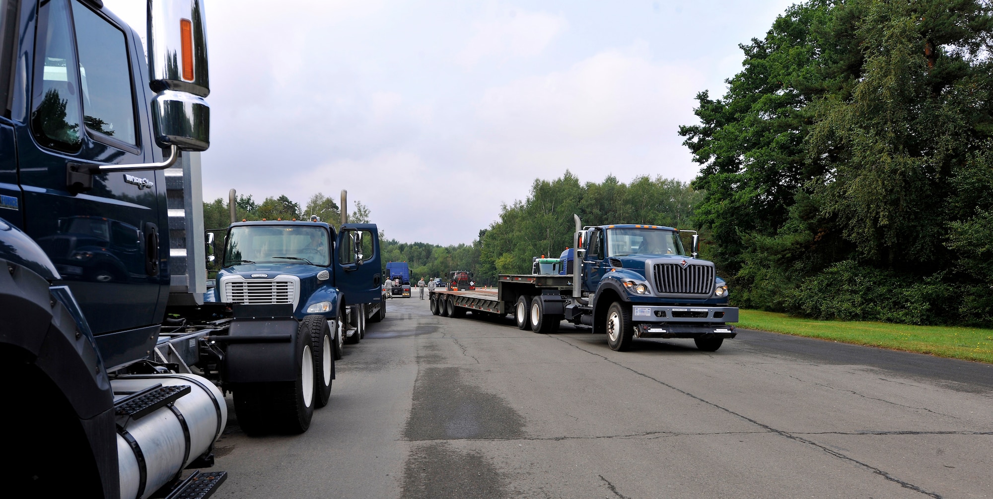 Air Force Civil Engineer Center instructors and students start a day of behind-the-wheel training for the AFCEC Tractor Trailer Training program Aug. 10, 2015, at Ramstein Air Base, Germany. This is the first time this program is being taught in U.S. Air Forces in Europe. It teaches students tractor trailer general knowledge, vehicle inspections, shifting proficiency, advanced backing maneuvers and over-the-road operating skills. (U.S. Air Force photo/Airman 1st Class Tryphena Mayhugh)