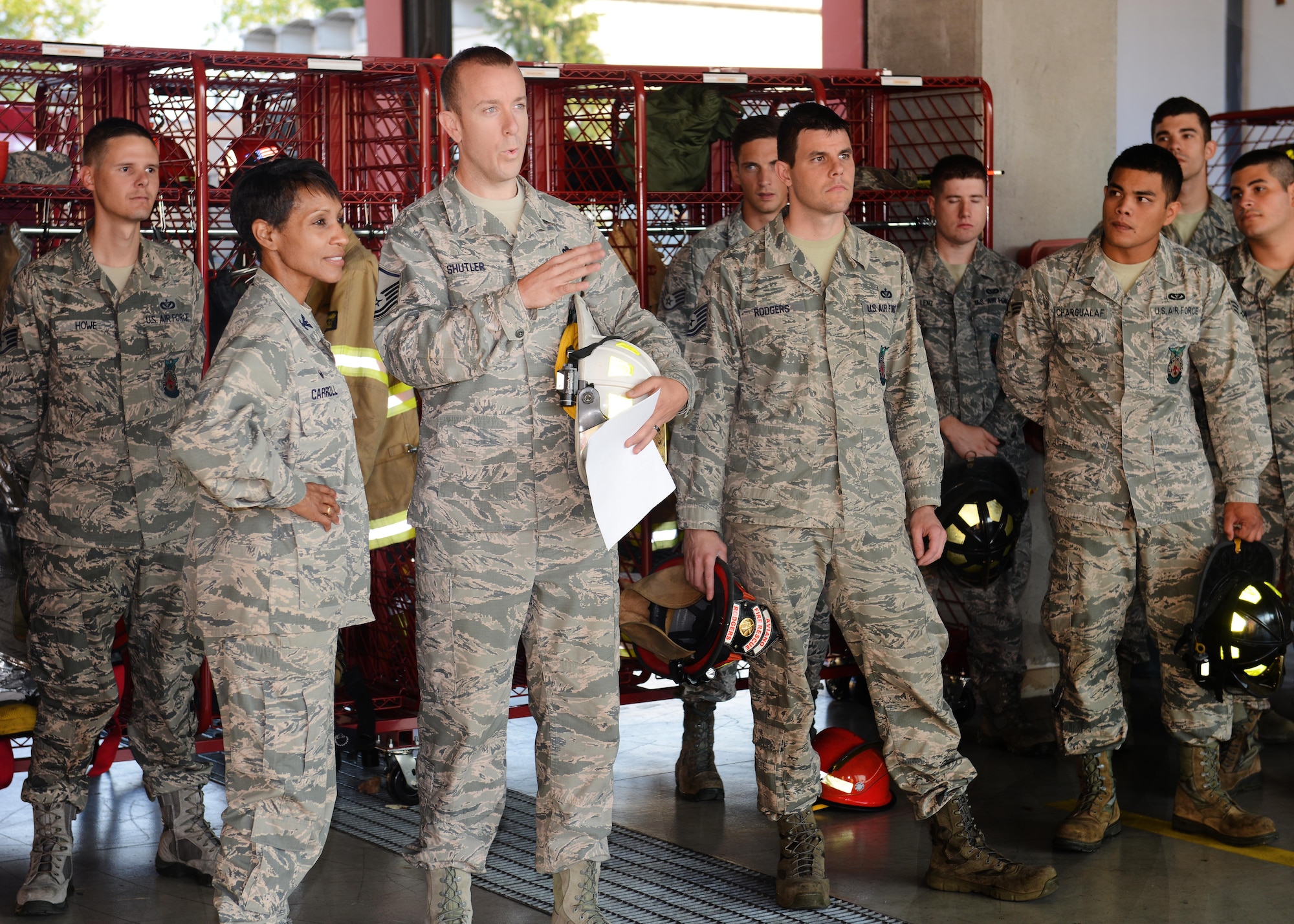 U.S. Air Force Col. Jenise Carroll, 31st Mission Support Group commander, speaks with Master Sgt. Walter Shutler, 31st Civil Engineer Squadron fire department assistant chief of operations, before the traditional “Housing Ceremony for New Fire Apparatus,” Aug. 13, 2015, at Aviano Air Base, Italy. The ceremony consists of transferring water into a new apparatus and firefighters pushing it into its respective stall. (U.S. Air Force photo by Airman 1st Class Deana Heitzman/Released)   