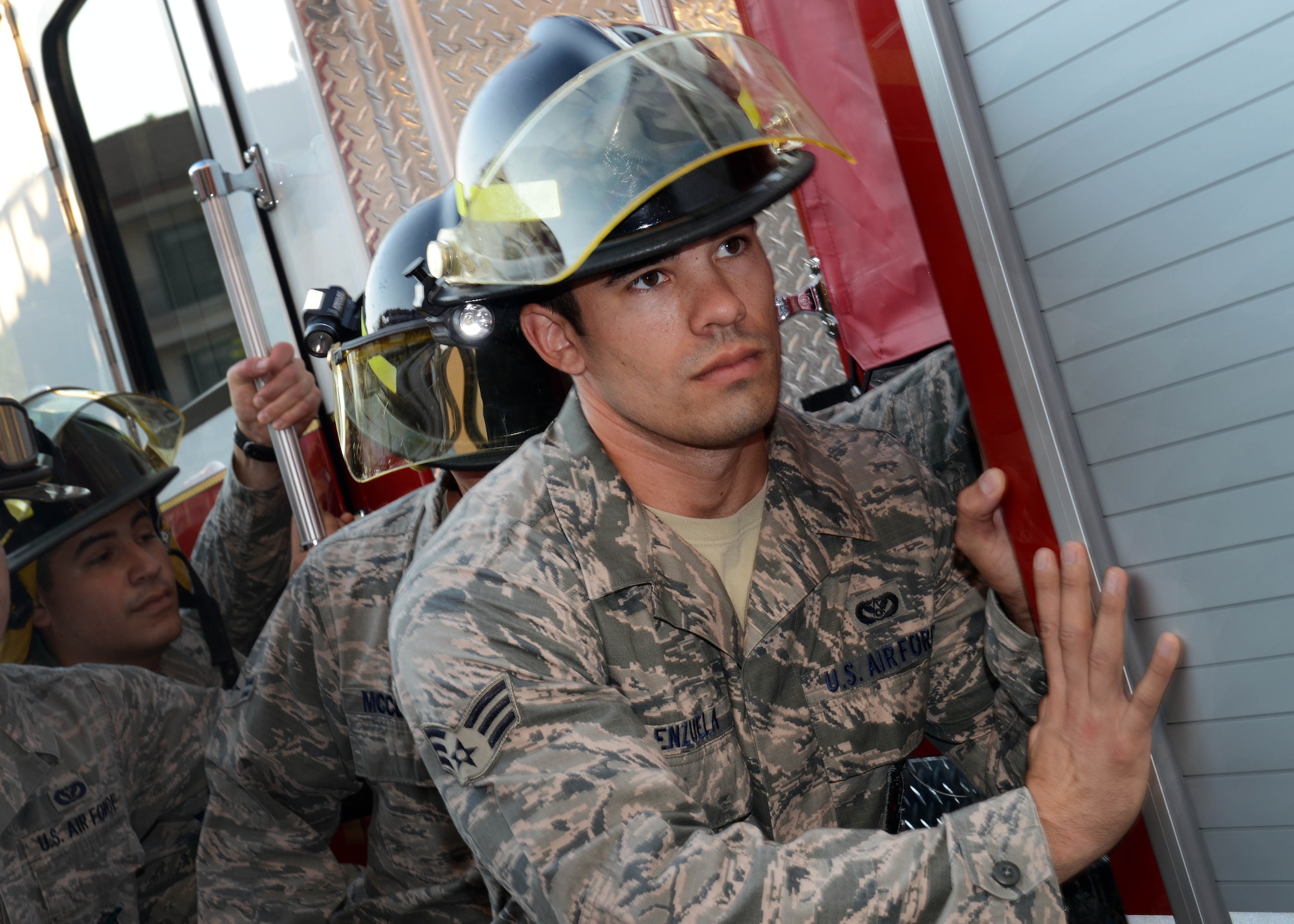 U.S. Air Force Senior Airman Alexander Valenzuela, 31st Civil Engineer Squadron firefighter, pushes Engine 11 into a stall during the traditional “Housing Ceremony for New Fire Apparatus,” Aug. 13, 2015, at Aviano Air Base, Italy. Pushing an engine into a stall began when fire wagons were drawn by horses. Horses could not pull the wagon into the stalls therefore firefighters would have to push it themselves. (U.S. Air Force photo by Airman 1st Class Deana Heitzman/Released)