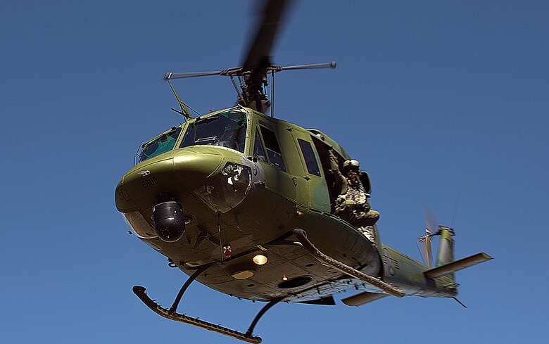 A flight engineer with F.E. Warren Air Force Base’s 37th Helicopter Squadron, scouts the terrain out the doors of a UH-1N Huey helicopter during a launch facility recapture exercise of the 2015 Global Strike Challenge Aug. 10, 2015. Crews had to navigate the Wyoming terrain, distinguish hostiles and insert a security forces tactical response force Airmen before capturing the launch facility south of Wheatland, Wyo. (U.S. Air Force photo by Airman 1st Class Brandon Valle)