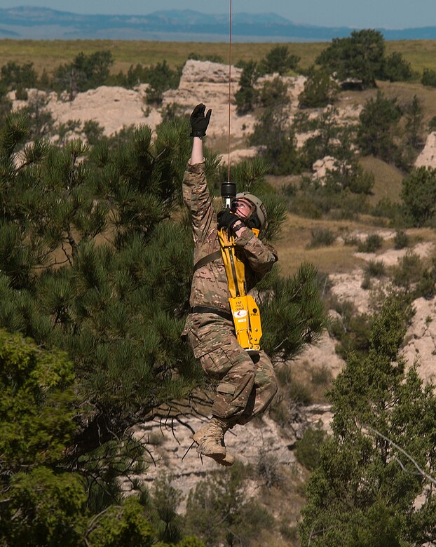 Malmstrom Air Force Base’s Staff Sgt. Kyle Hart, 741st Missile Security Forces Squadron, is hoisted up to a 40th Helicopter Squadron UH-1N Huey helicopter over Camp Guernsey, Wyo., Aug. 9, 2015. Hart and his teammates were competing in the 2015 Global Strike Challenge helicopter competition which names the best missile and bomber wings in the U.S. Air Force. (U.S. Air Force photo by R.J. Oriez/Released)