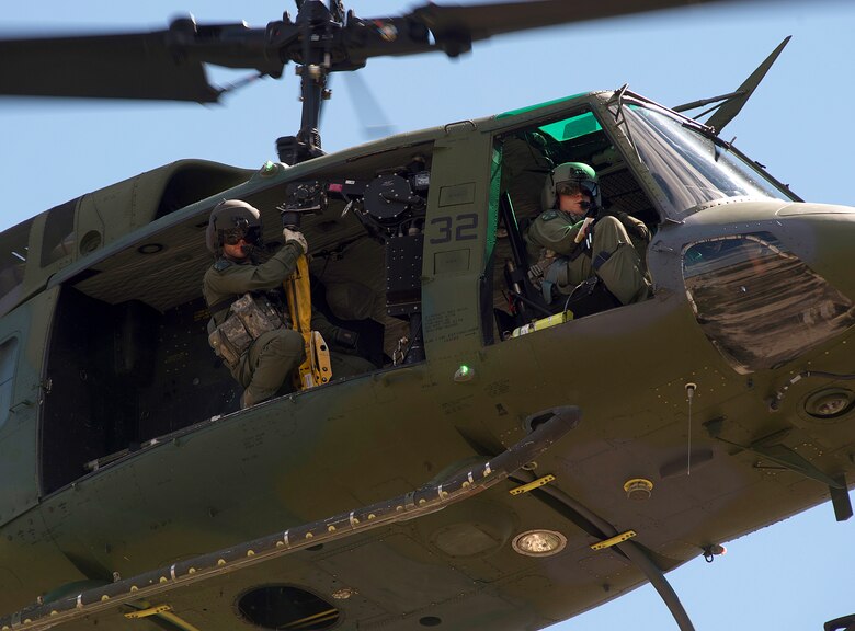 Staff Sgt. Brad Reeves, 37th Helicopter Squadron, prepares to lower a penetrator from a UH-1N Huey helicopter Aug. 9, 2015, during the 2015 Global Strike Challenge helicopter competition at Camp Guernsey, Wyo. Crews from each of the three squadrons which make up  the 582nd Helicopter Group, whose mission is to support the missile wings of the Air Force Global Strike Command, had their skills tested as they competed in the search and rescue exercise, an emergency security response exercise and a night tactical exercise. (U.S. Air Force photo by R.J. Oriez/Released)