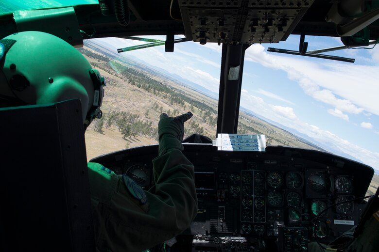 Capt. Preston Moon, 37th Helicopter Squadron pilot, flies a UH-1N Huey Helicopter during a familiarization flight Aug. 8, 2015, in preparation for the Global Strike Challenge competition. Air crews from the 37th, 40th and 54th Helicopter Squadrons participated in the 2015 GSC and competed through various challenges during the three-day event at Camp Guernsey, Wyo. (U.S. Air Force photo by Airman 1st Class Malcolm Mayfield/Released)