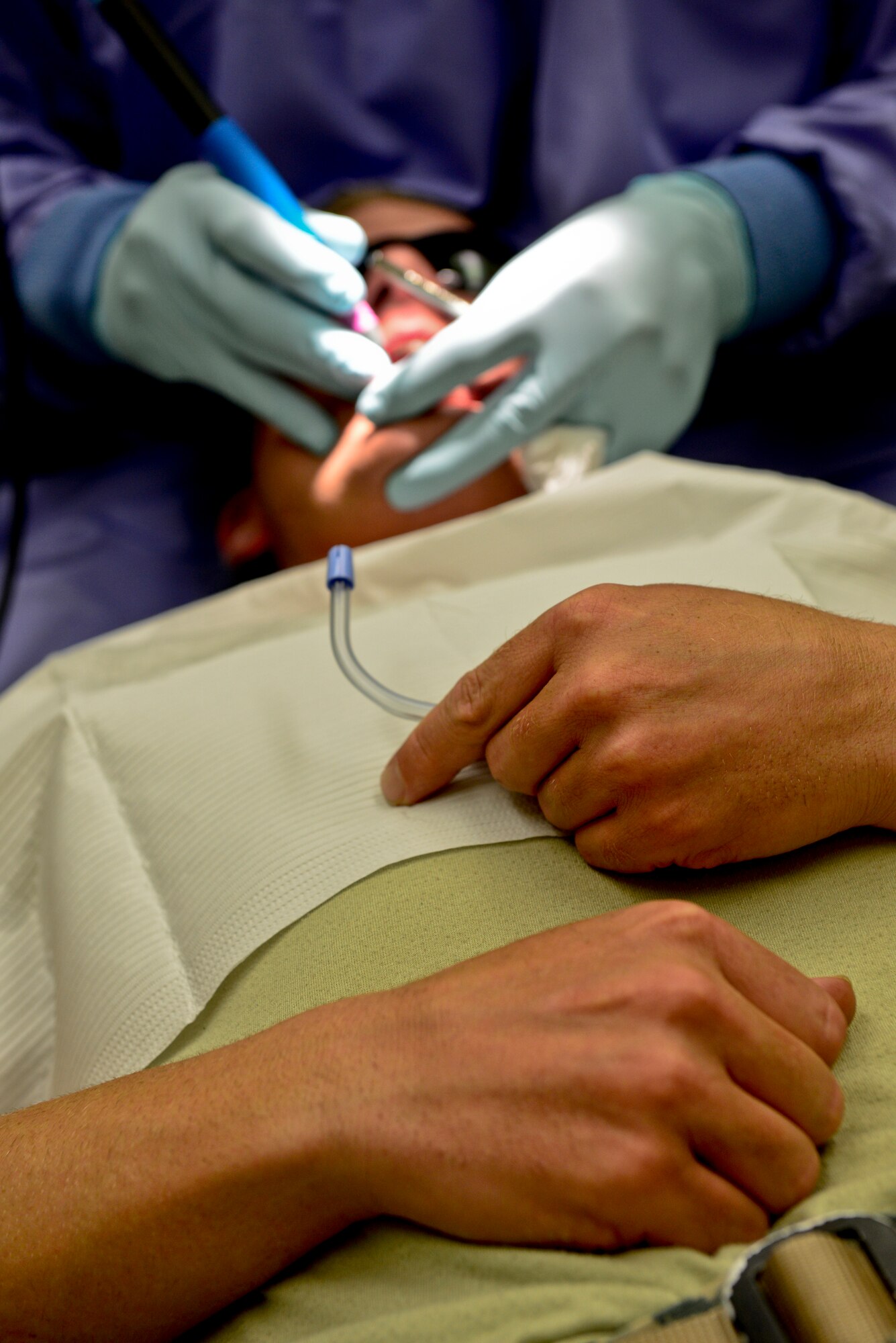 Tech. Sgt. William Spraggins, 51st Civil Engineer Squadron Airman dorm leader, holds a mouth rinse during his annual teeth cleaning on Osan Air Base, Republic of Korea, Aug. 7, 2015. The clinic here, consisting of 45 active-duty service members and five civilians, takes care of more than 7,000 Team Osan service members, command sponsored dependents, AAFES workers, Department of Defense contractors and retirees on space-available cases. (U.S. Air Force photo/Senior Airman Kristin High)  