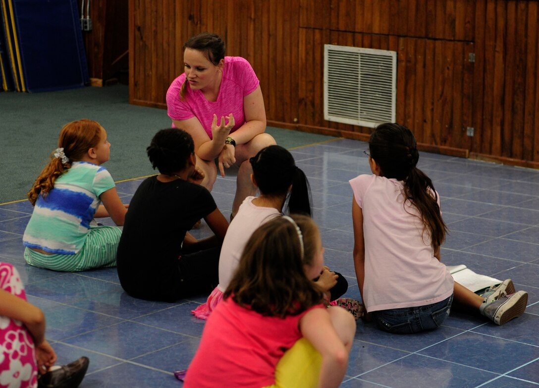 Chelsey Campbell, Missoula Children’s Theatre tour actor and director, speaks to a group of children from the local community about their lines Aug. 6, 2015, at Incirlik Air Base, Turkey. Campbell was one of two tour actors and directors who traveled to Incirlik AB to assist the local children in putting on the MCT’s musical version of Rapunzel. (U.S. Air Force photo by Senior Airman Krystal Ardrey/Released)