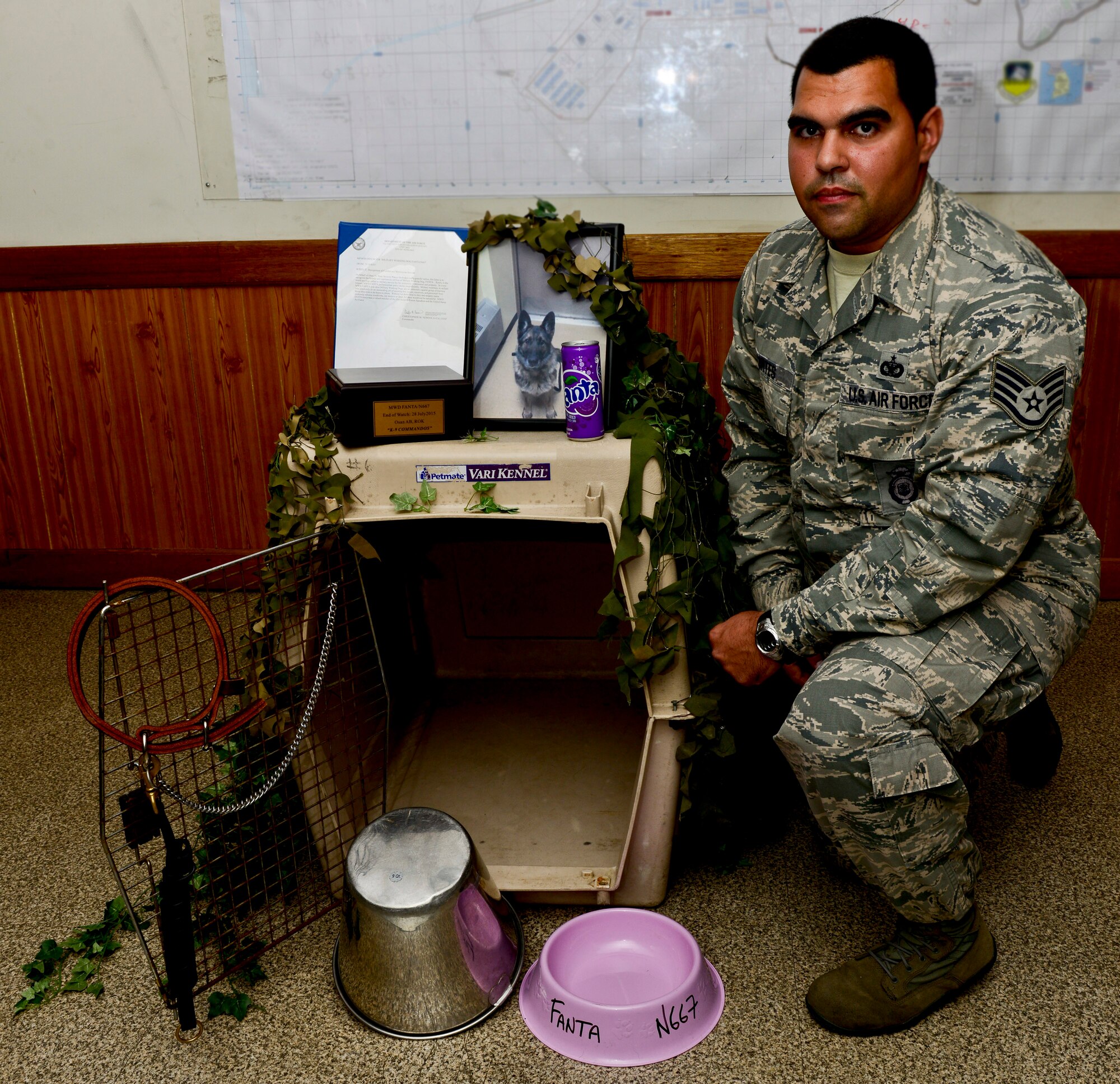Staff Sgt. Bernardo Cortes, 51st SFS military working dog handler, kneels next to an empty kennel after a memorial service for Military Working Dog Fanta on Osan Air Base, South Korea. The empty kennel represents the life and contributions of Fanta, who served eight years before passing on July 28, 2015. (U.S. Air Force photo/Senior Airman Kristin High)